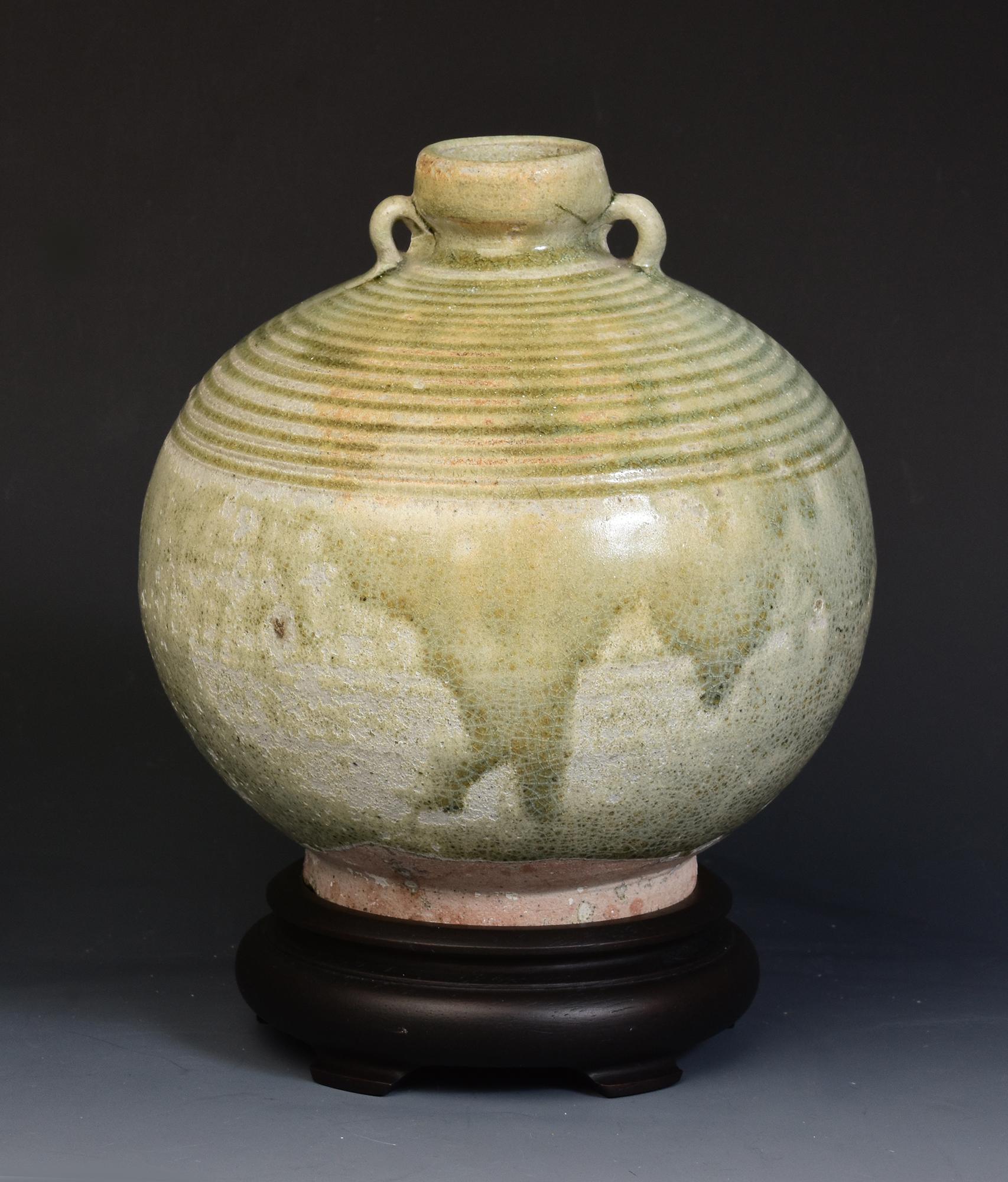 Antique Thai Sukhothai celadon glazed pottery bottle.

Age: Thailand, Sukhothai Period, 14th - 16th Century
Size: Height 17.3 C.M. / Width 16.8 C.M. (size excluding stand)
Condition: Nice condition overall (some expected degradation due to its
