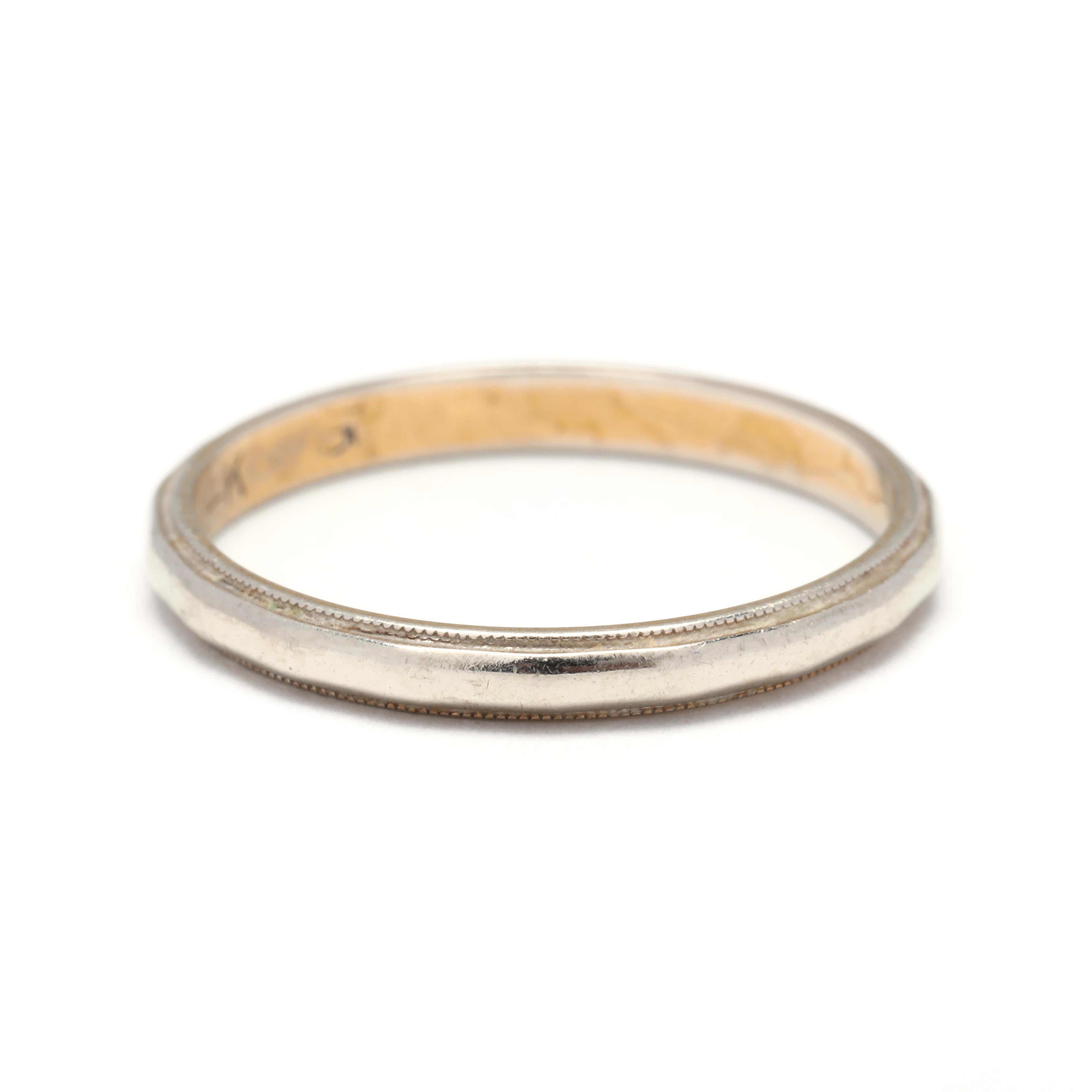 A vintage 14 karat bicolor gold faceted wedding band. This band features a faceted eternity design with a milgrain edge that is white gold on the outside and yellow gold on the inside. This is the perfect stackable band!



Ring Size 6



Width: