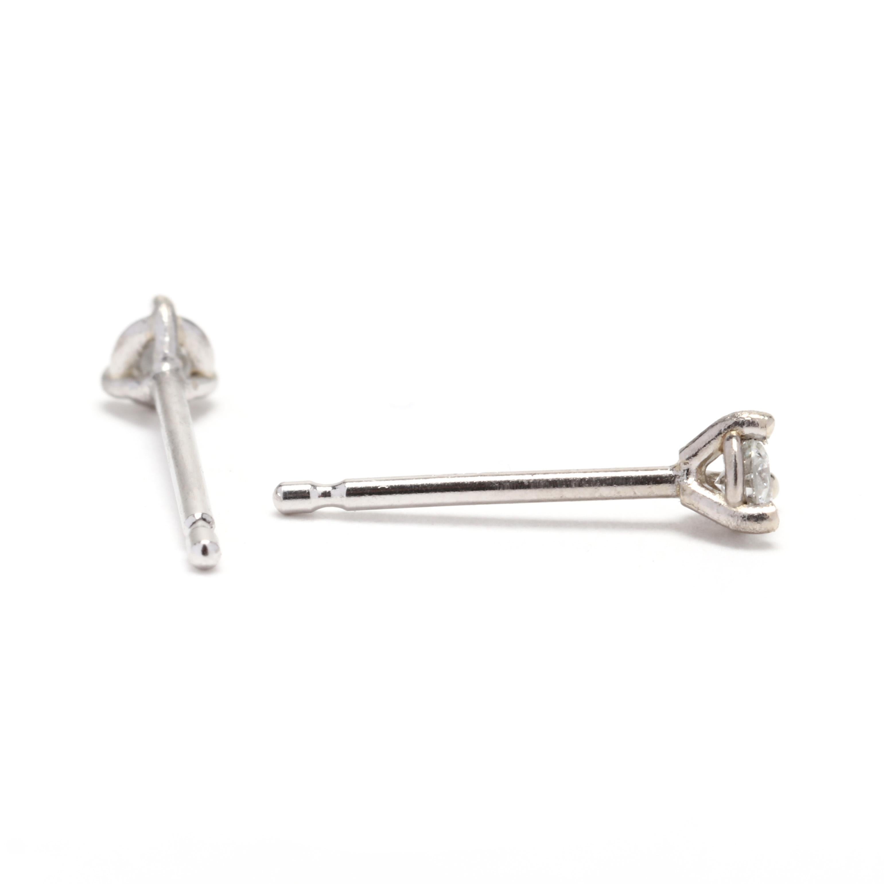 A pair of 14 karat white gold diamond stud earrings. These earrings feature full cut round diamonds weighing approximately .12 total carats set in a martini 3 prong setting with pierced butterfly backings.



Stones:

- diamonds, 2 stones

- full