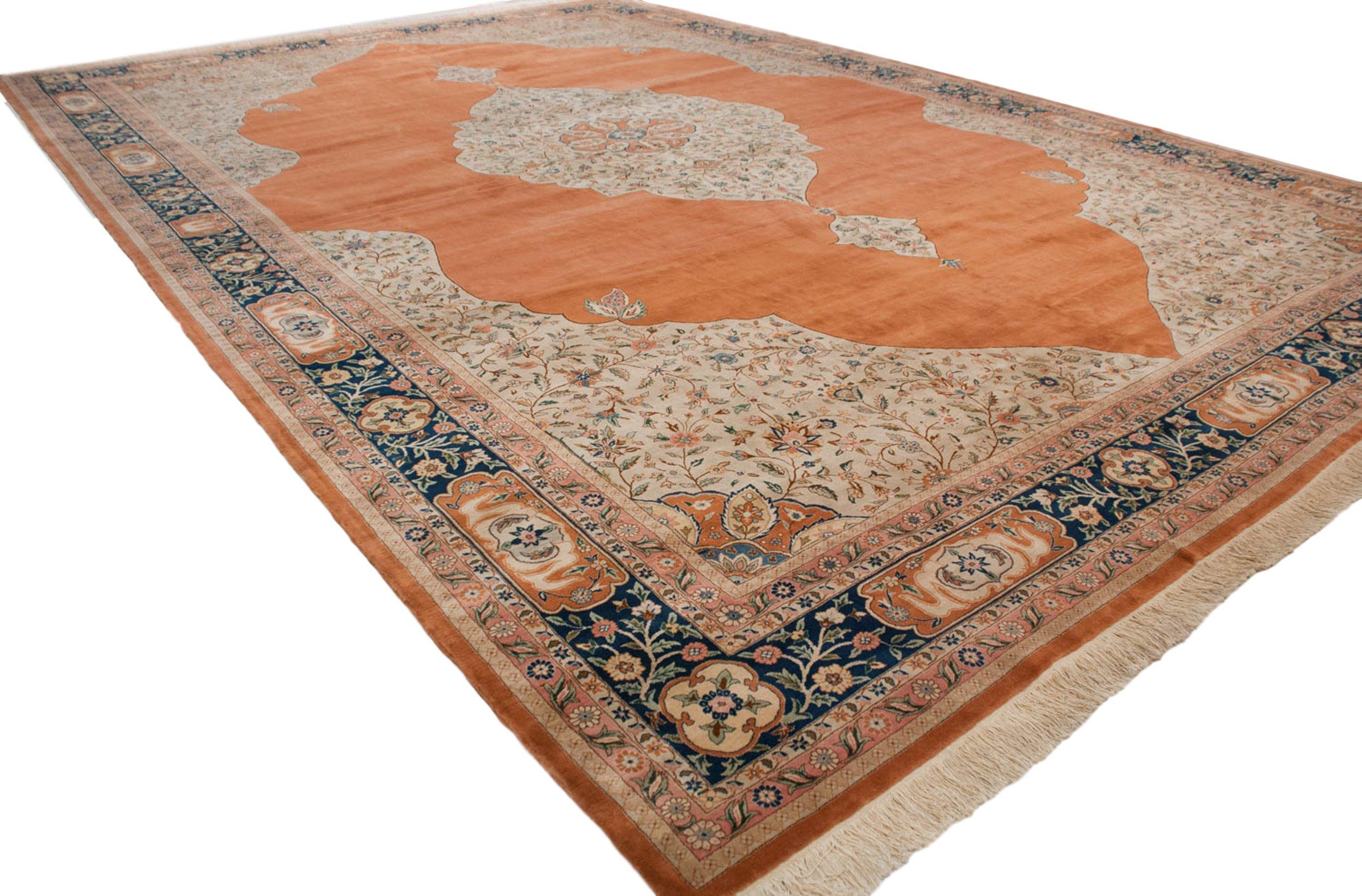:: Tremendous scale and proportion in a classic Tabriz design, bearing large center medallion with roundel interior main medallion, surrounded by vinery, buds, blossoms, and more. Main field in a beautifully abrashed range in the orange family, with