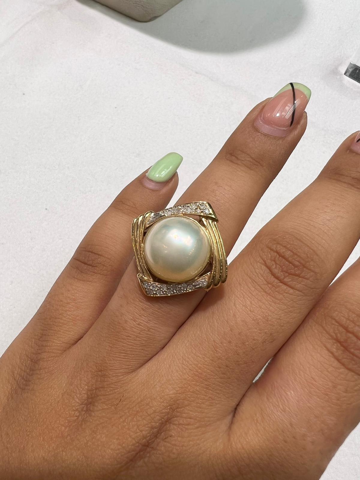 14X6mm Mabe pearl with 14k yellow gold ring with diamonds
A cultivated blister pearl that is produced differently than other cultured pearls is a mabe pearl. A 14*6mm mabe pearl is developed against the interior of the shell rather than inside the
