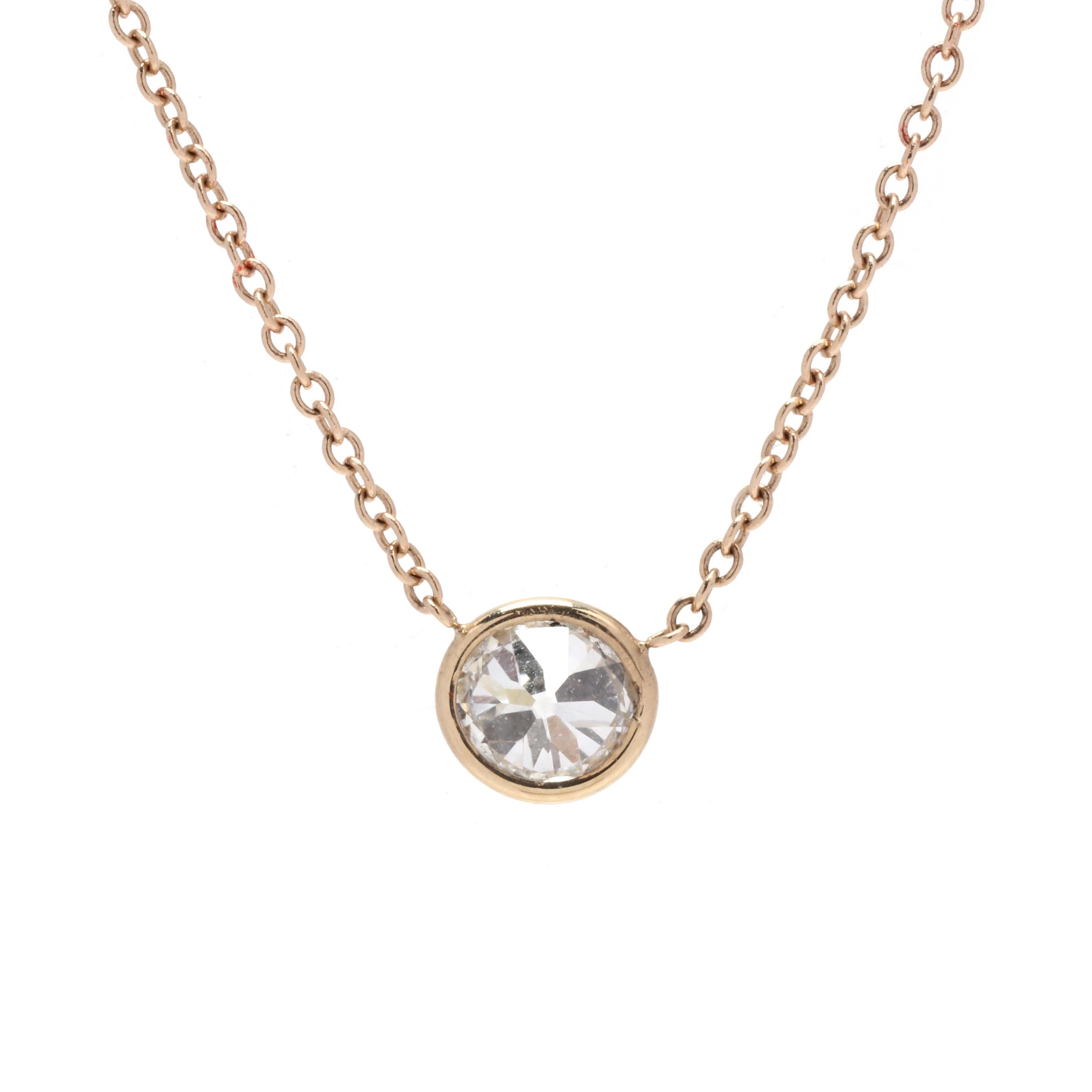 A 14 karat yellow gold stationary diamond bezel pendant necklace. This necklace features a bezel set old mine cut diamond weighing approximately .44 carat suspended from a thin cable chain with a lobster clasp.

Stone:

- diamond, 1 stone

- old