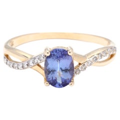 14Y Oval Blue Stone & Diamond Cross Over Ring