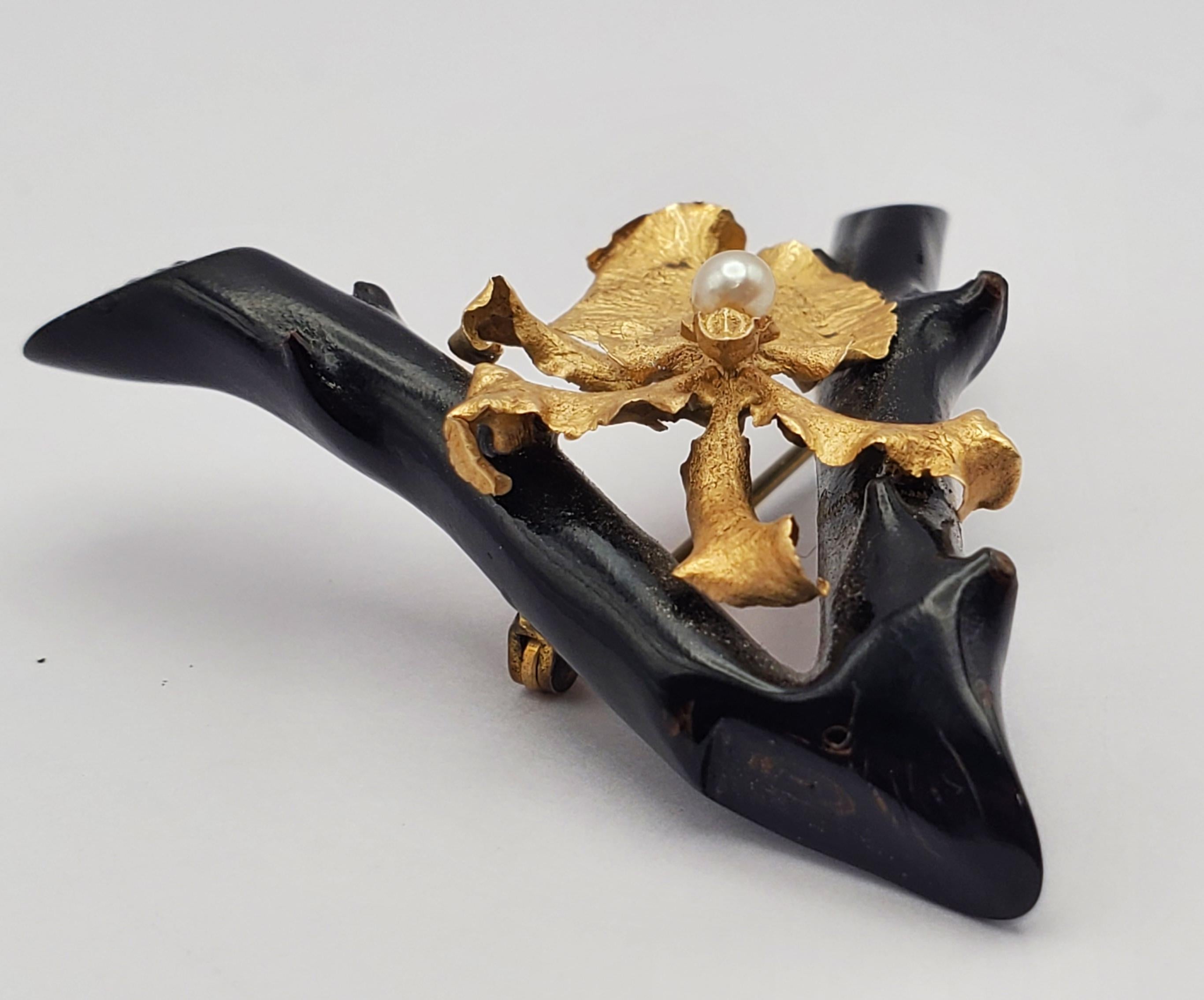 Wonderful rare vintage black coral and 14k yellow gold Iris flower brooch. The black coral branch pin features a wishbone shape overlaid with a beautifully detailed rendering of an Iris flower with a cream colored freshwater pearl in the center. The