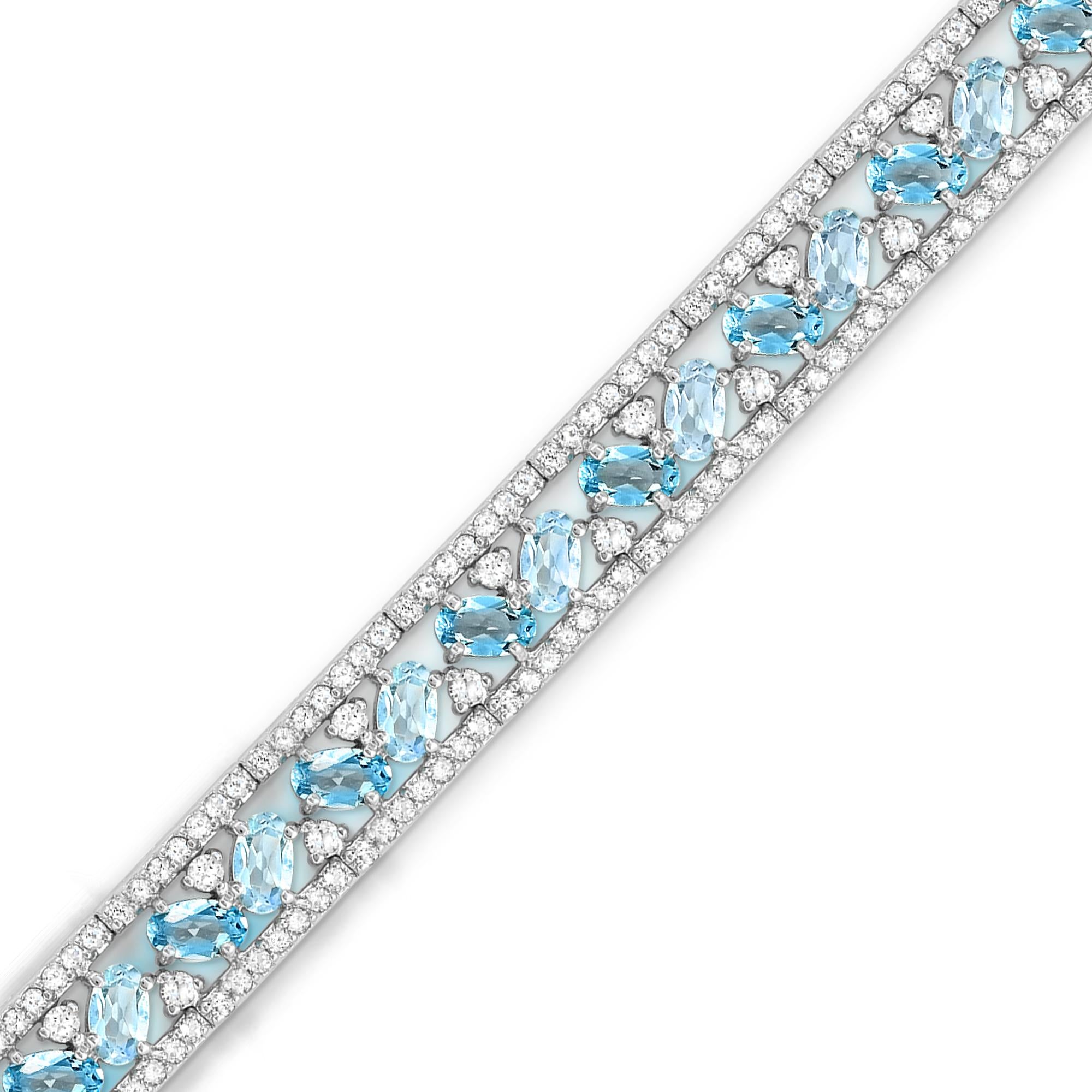 This sparkly modern designed bracelet features oval Swiss blue and sky blue topaz accented by round white topaz gemstones secured with a custom-designed open-box closure. 

Metal: Sterling Silver
Gemstones:
Oval Swiss Blue Topaz/Sky Blue Topaz: 5.0