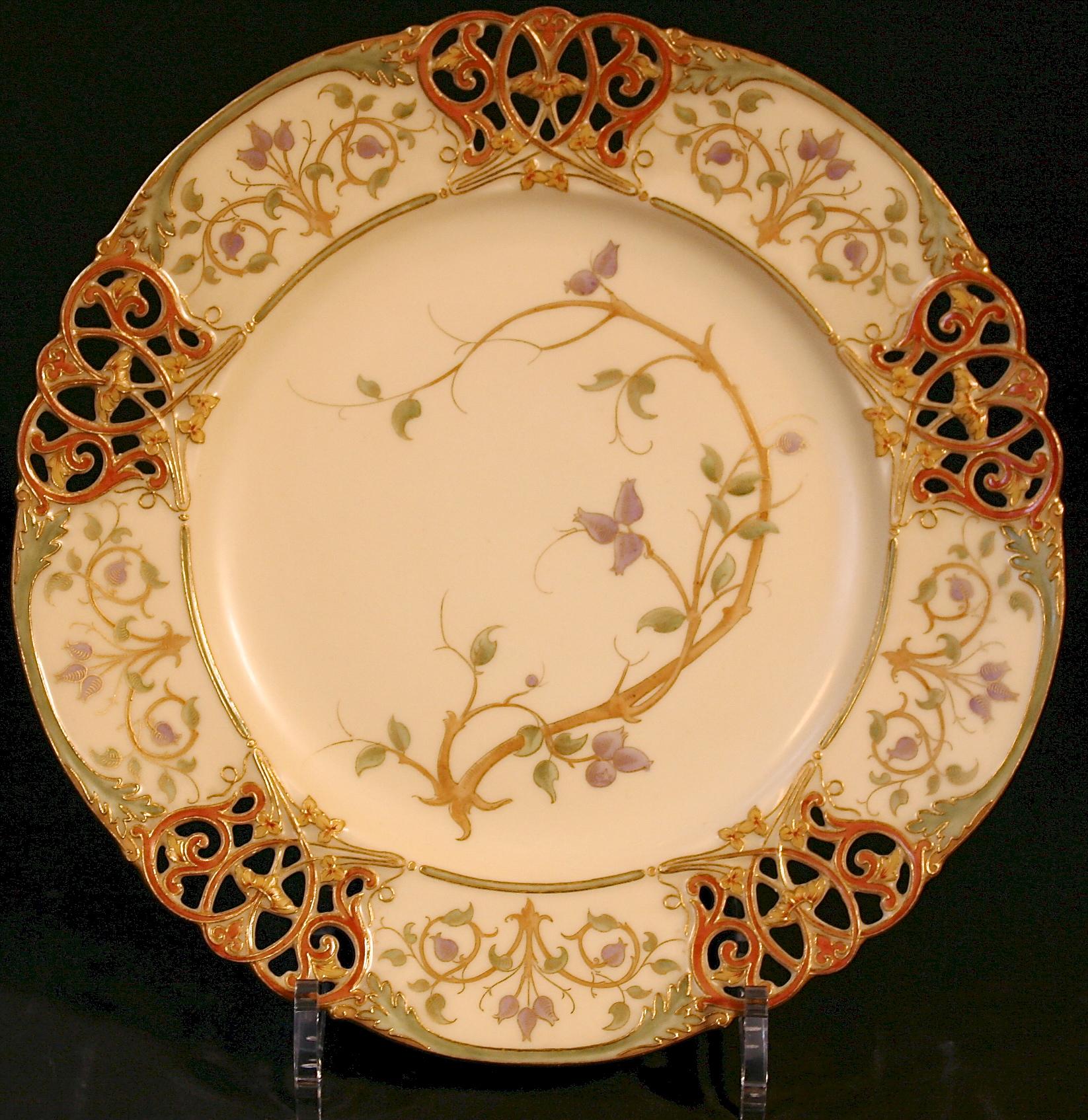 Large service of 15 hand painted and reticulated or pierced plates from the esteemed English firm of Royal Worcester. Each plates is elegantly painted in a naturalistic style with a different species of wildflower. The rim is decorated with 3 panels