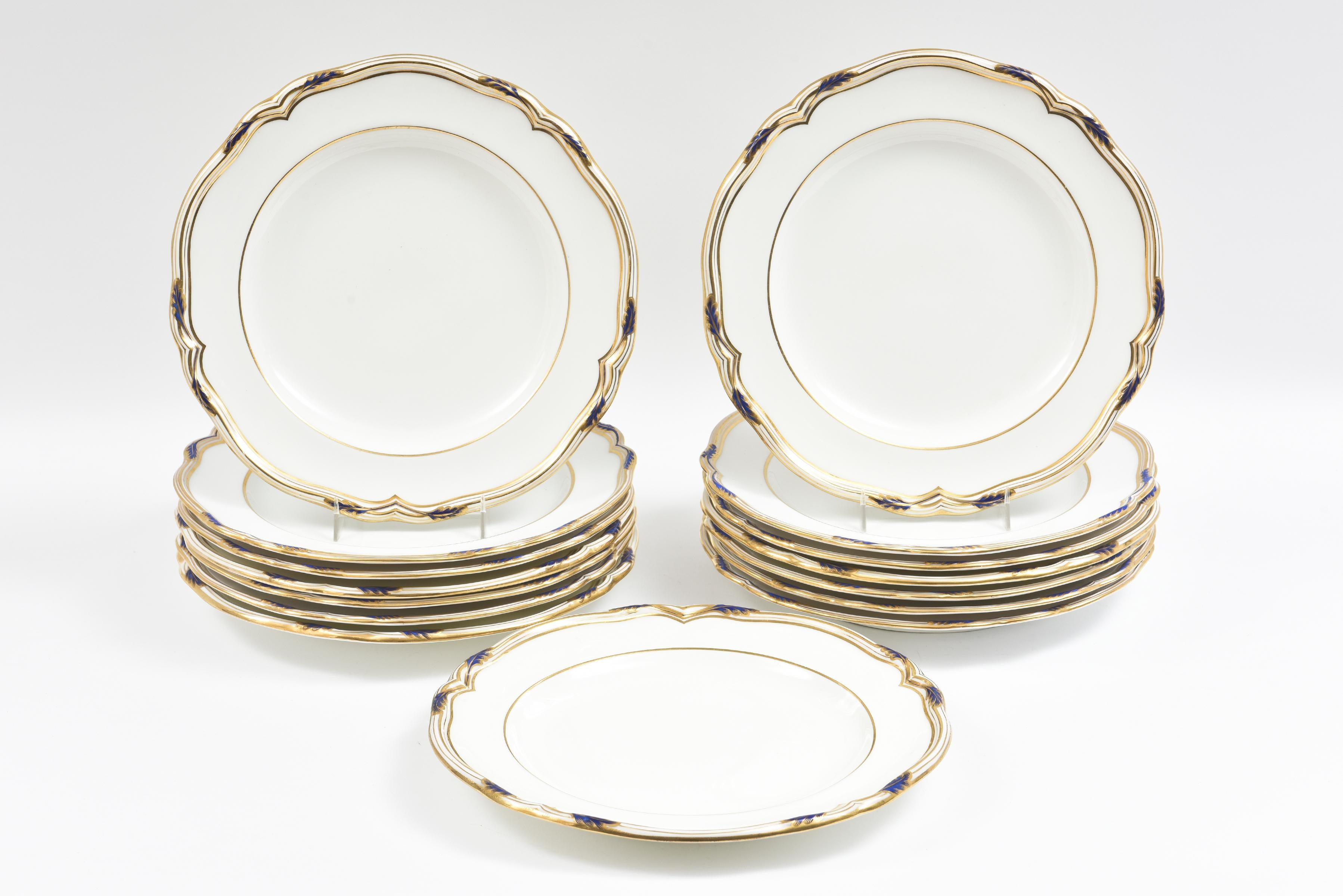 A Classic and elegant pattern from one of England's oldest firms: Copeland Spode. This dinner plate features a slightly scalloped edge which is accented with hand painted cobalt blue and 24-karat gilded rims. Custom ordered through one of Boston's