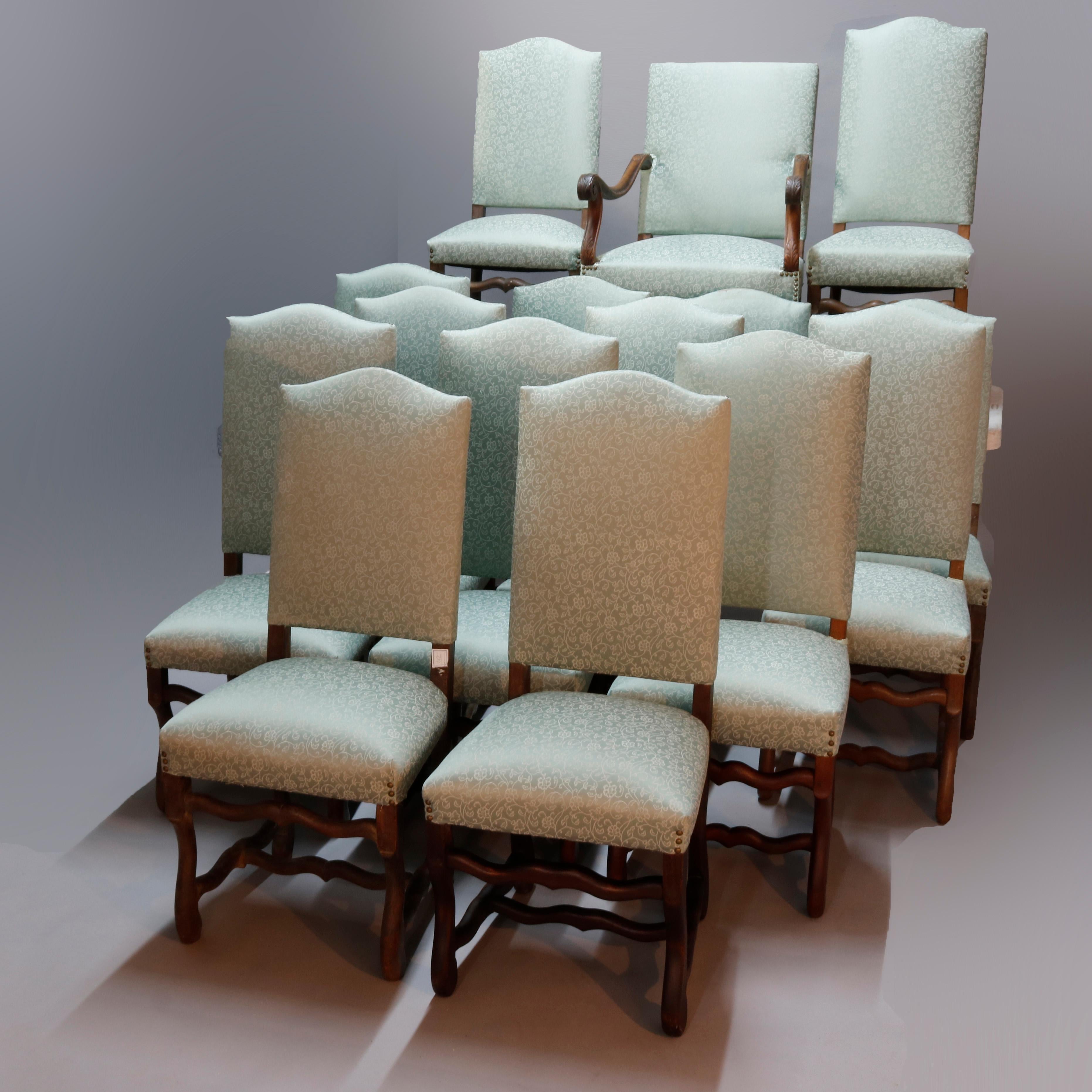An antique set of fifteen French Renaissance dining chairs offer tall shaped backs with carved walnut scroll form frames, newly upholstered, 19th century

Measures: One armchair: 40