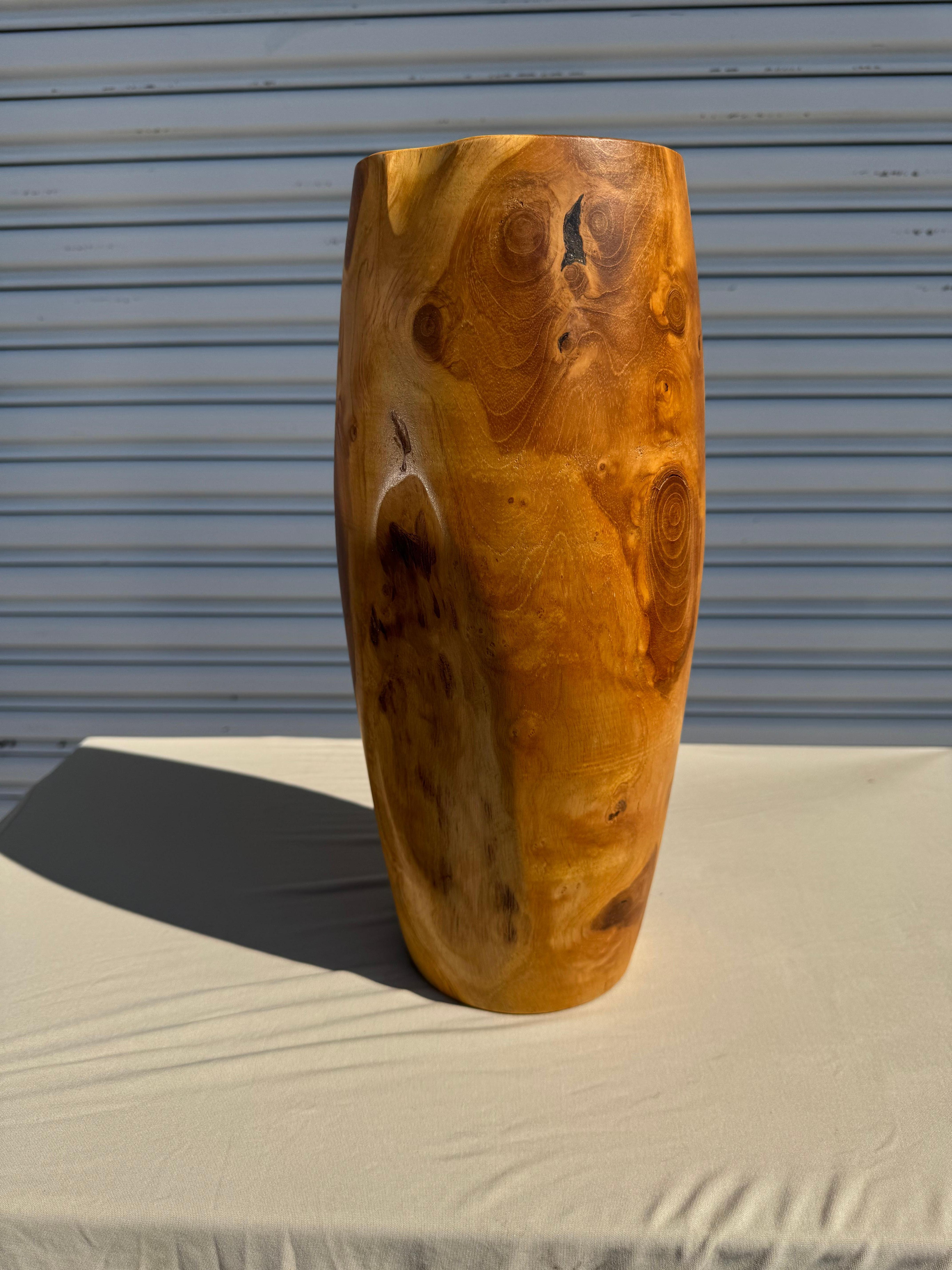 This is a hand turned vase made of the root of a burlwood tree.
It stands 15