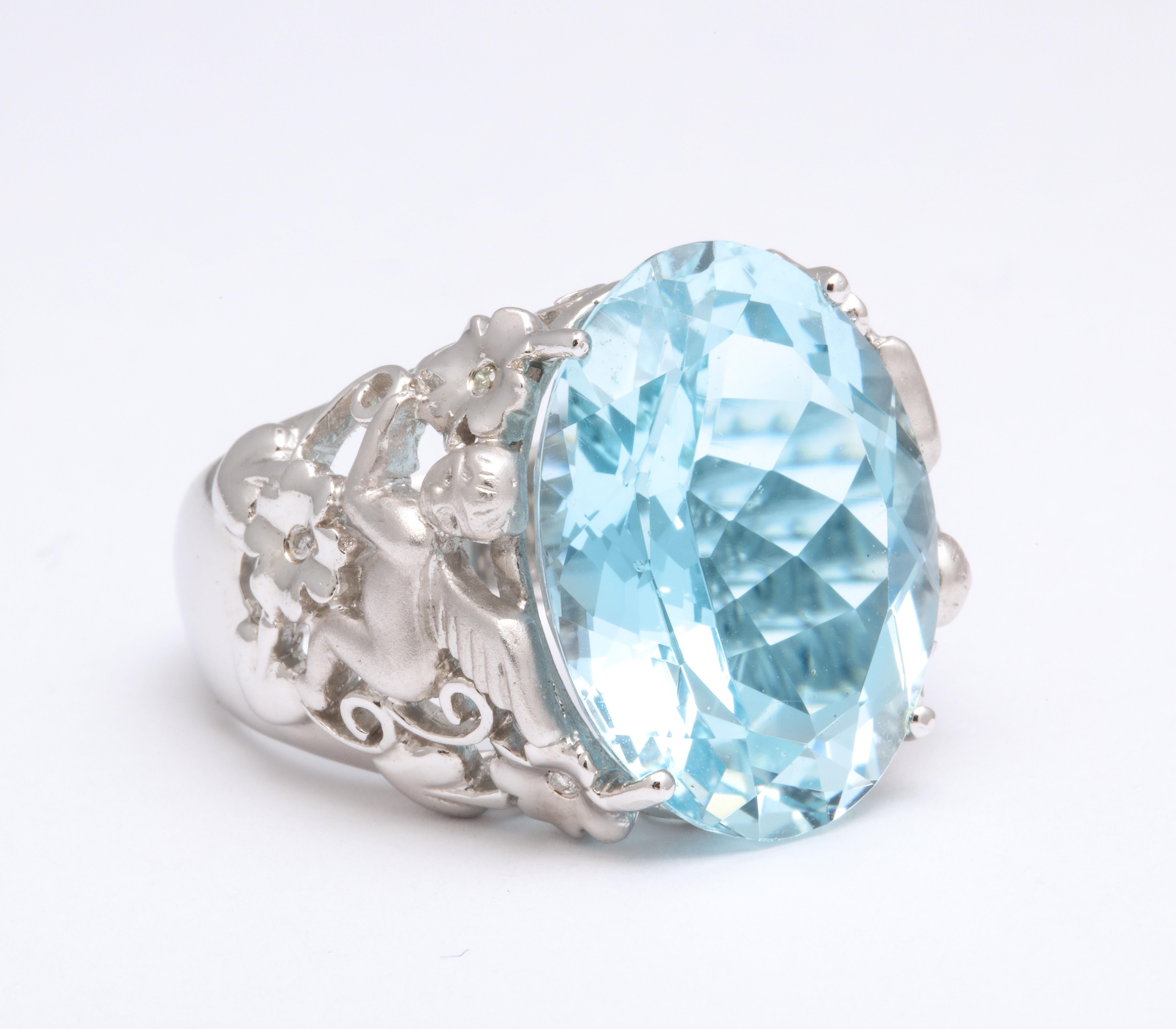 
A UNIQUE piece!

15.10 carat oval Aquamarine set in na intricate 18k white gold setting with angel and flower detail.

0.06 carats of diamonds. 

Currently a size 7.5, this ring can easily be resized. 

Approx 19.6 mm long
