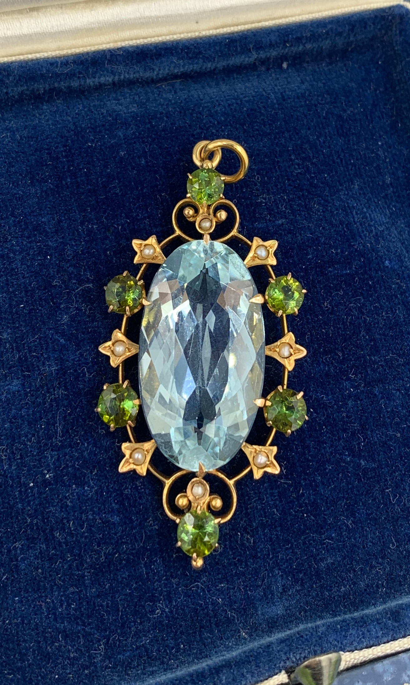 We are so delighted to have this extraordinary antique Art Deco 15 Carat natural Aquamarine and Green Tourmaline and Pearl Pendant in 14 Karat Gold.  The magnificent Aquamarine is 25mm long and the gem has an exquisite oval shape, fine blue color