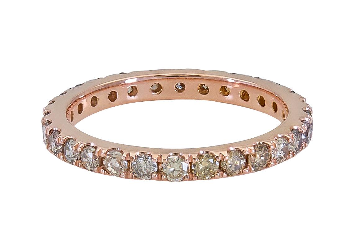 Unique and stylish eternity band that can be used as a fashionable ring as well. Showcasing a row of champagne or fancy brown diamonds weighing 1.50 carats total. Set in a traditional wedding band style made in 18k rose gold. 
Size 6.5 US.

Style is