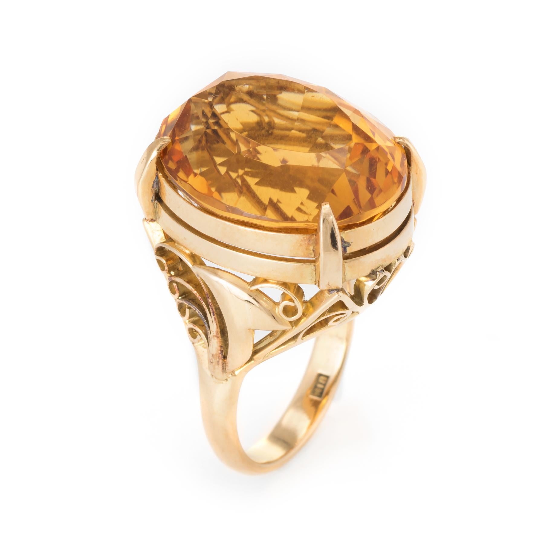 Bold and distinct vintage cocktail ring (circa 1950s to 1960s), crafted in 18 karat yellow gold. 

Oval faceted citrine measures 18mm x 15mm (estimated at 15 carats). The citrine is in excellent condition and free of cracks or chips.   

The citrine