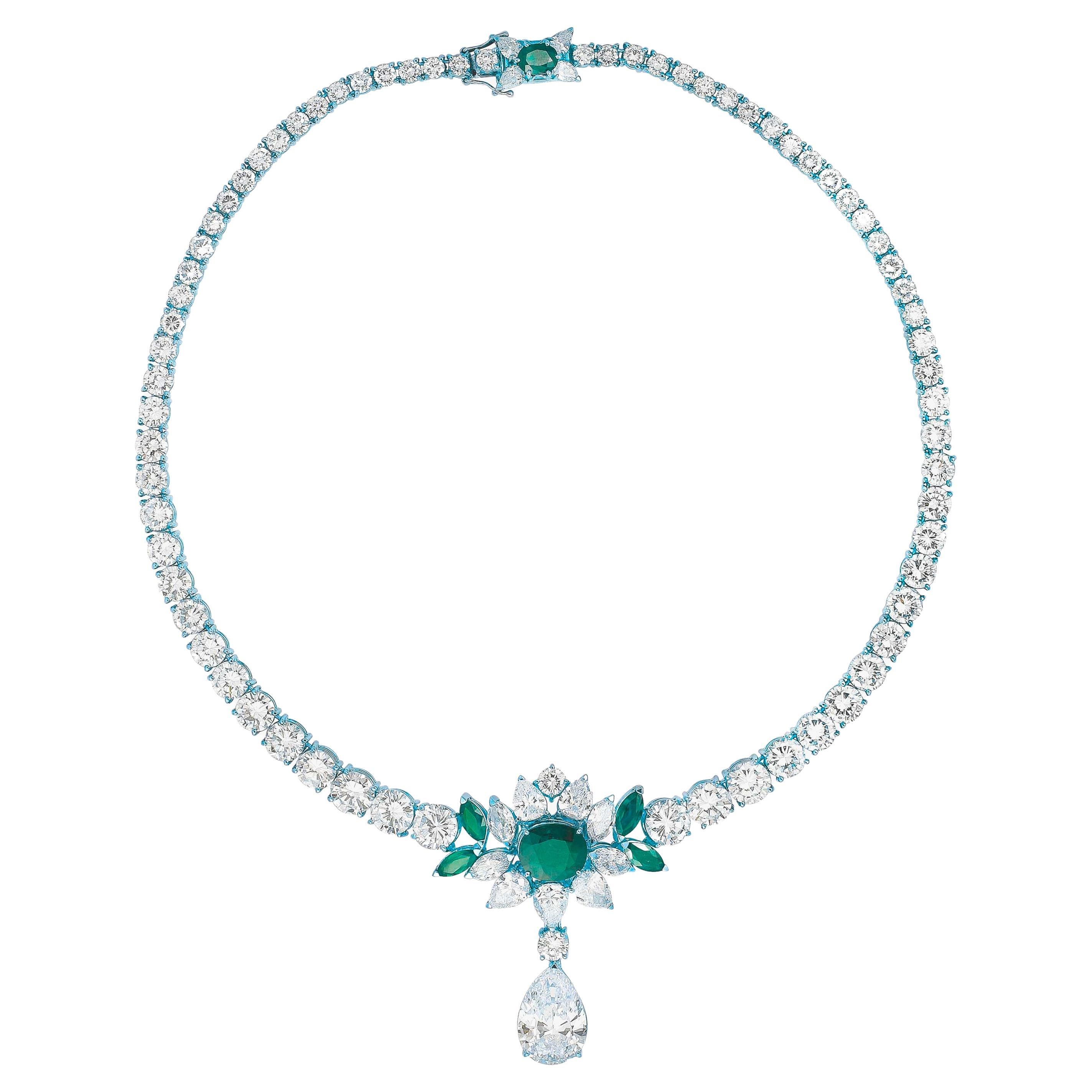 A DIAMOND AND EMERALD NECKLACE

The necklace features a circular-cut diamond graduated design and is adorned with an oval-cut emerald of approximately 5 carats. A pear-shaped diamond, mounted in gold, weighing approximately 10 carats, is suspended