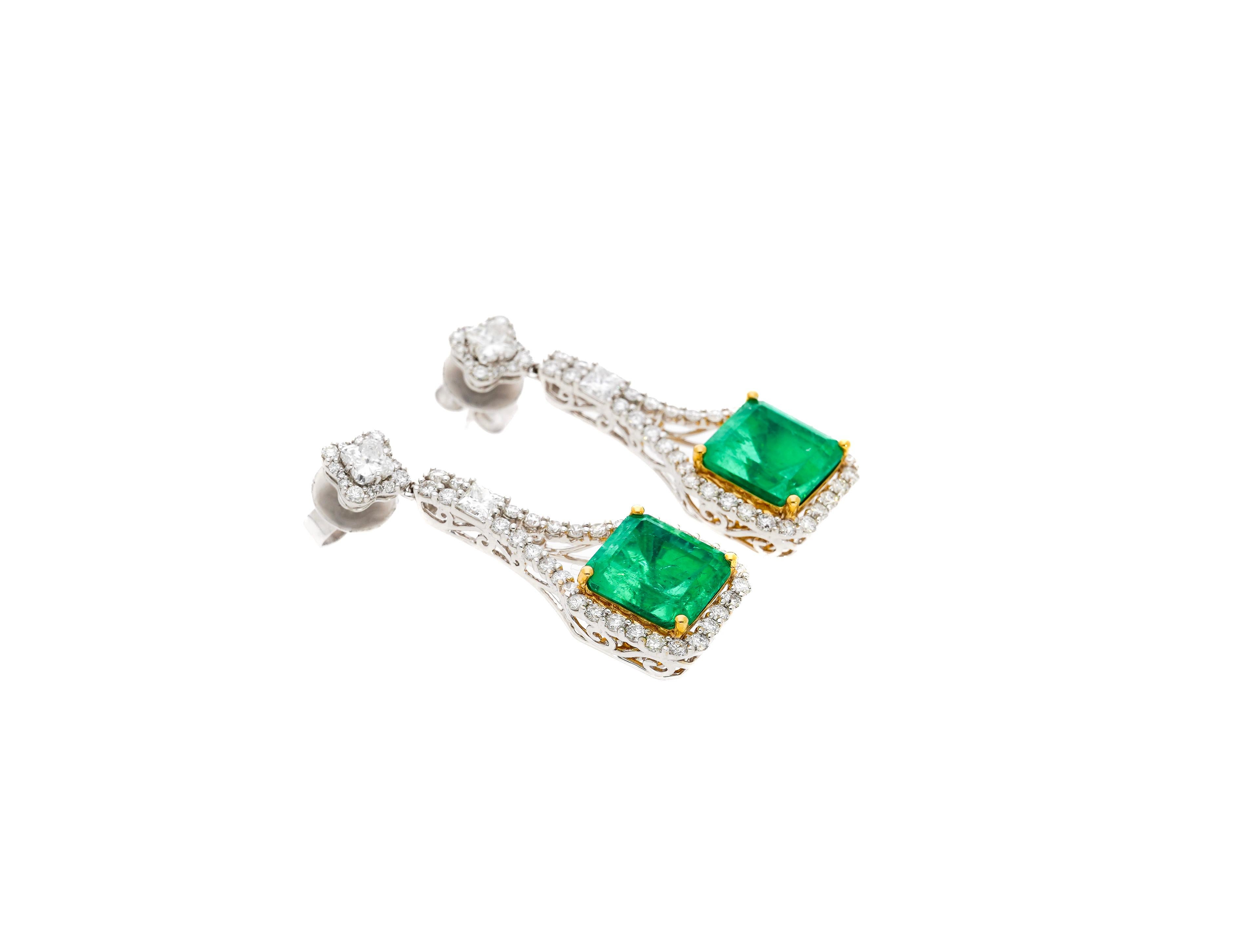 GRS Certified perfect matching pair of minor oil pastel green Colombian emeralds and diamond drop earrings. 

Details: 
✔ Item Type: Dangle Earrings 
✔ Metal: 18k white & yellow gold
✔ Weight: 11.84 grams
✔ Setting: Prong, Halo 
✔ Closure: