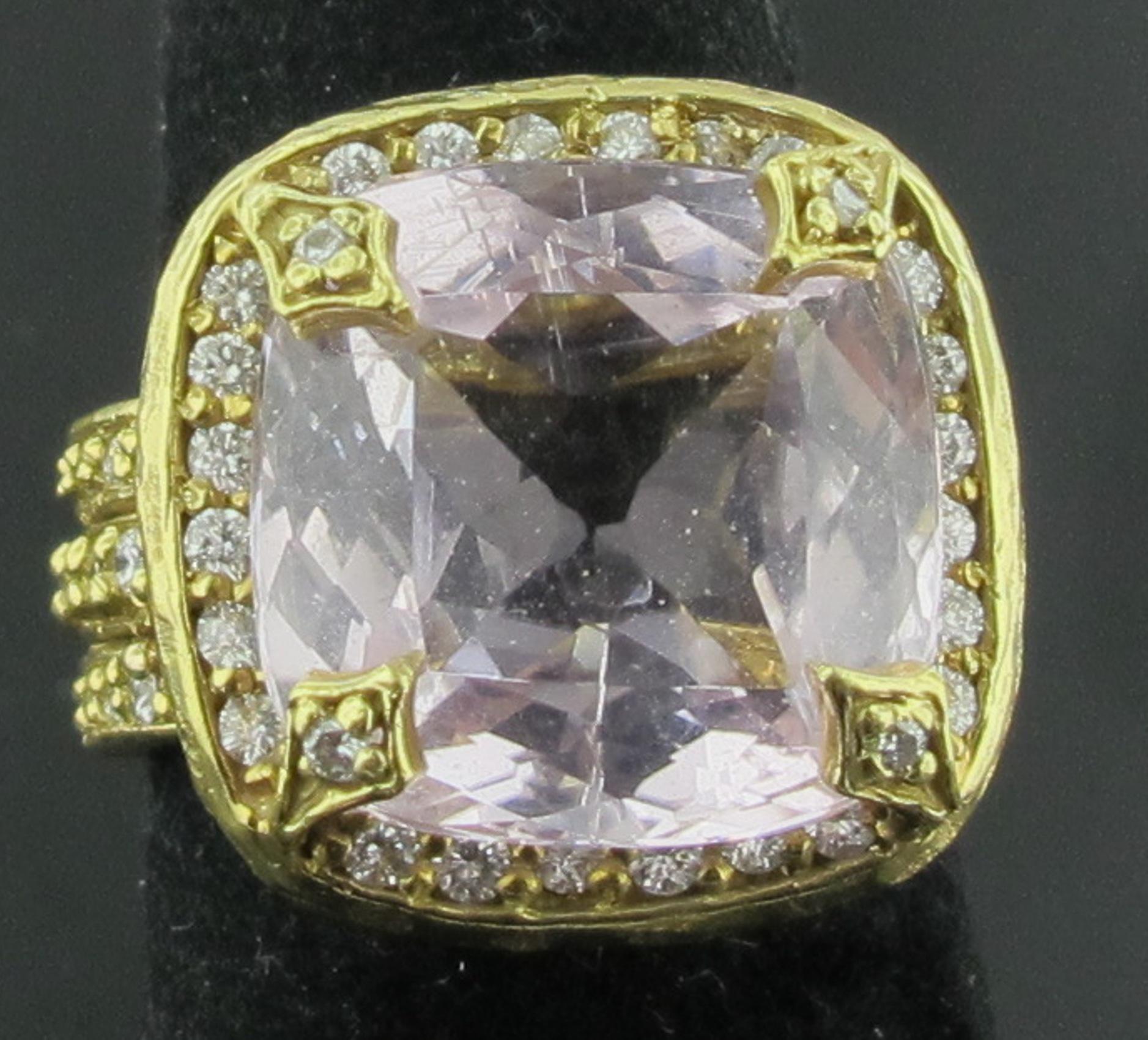 Set in 18 karat yellow gold is a 15 carat Cushion Mixed Cut Morganite with 56 round brilliant cut diamonds weighing a total of approximately 1.00 carats.  Ring size is 7. This ring can be sized. 