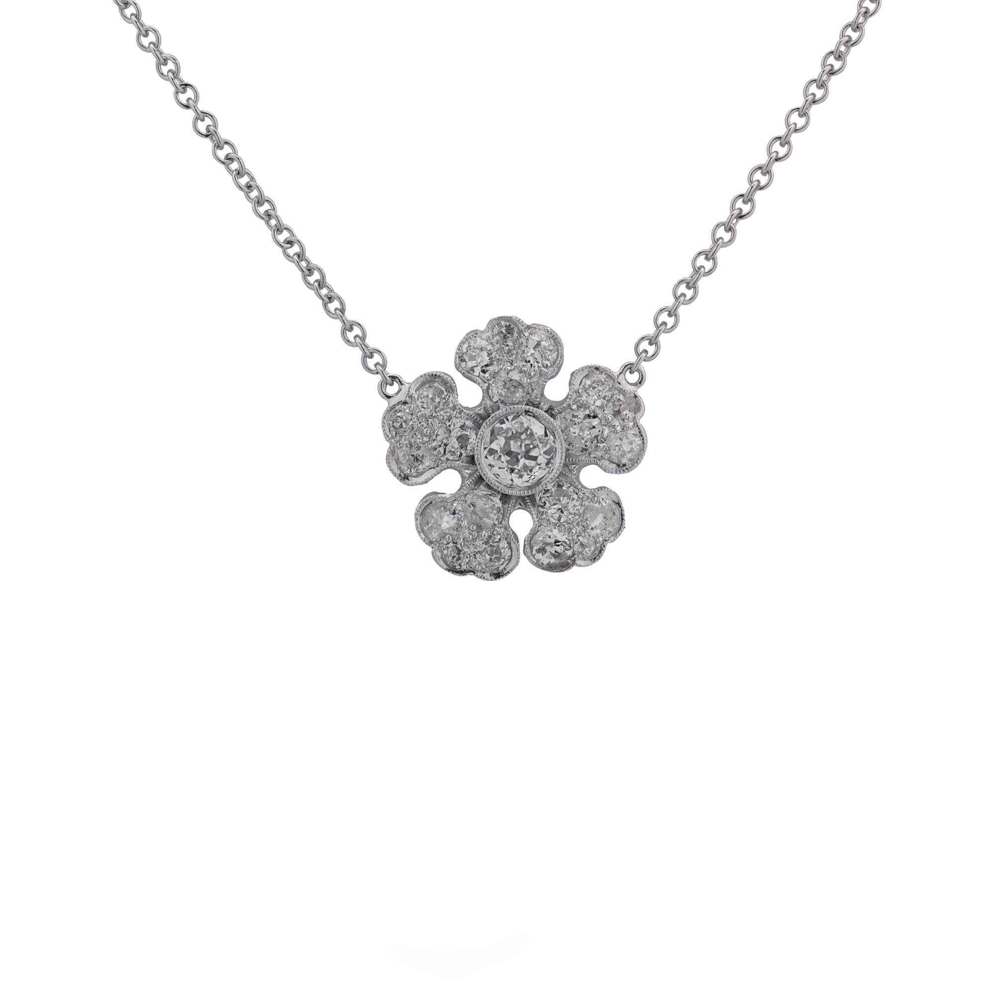 Gorgeous necklace and pendant crafted in platinum and 18 karat white gold featuring 21 European cut diamonds weighing approximately 1.5 carats total, G-J color VS-SI clarity set in a whimsical flower. The 1 mm chain measures 18.5 inches in length.