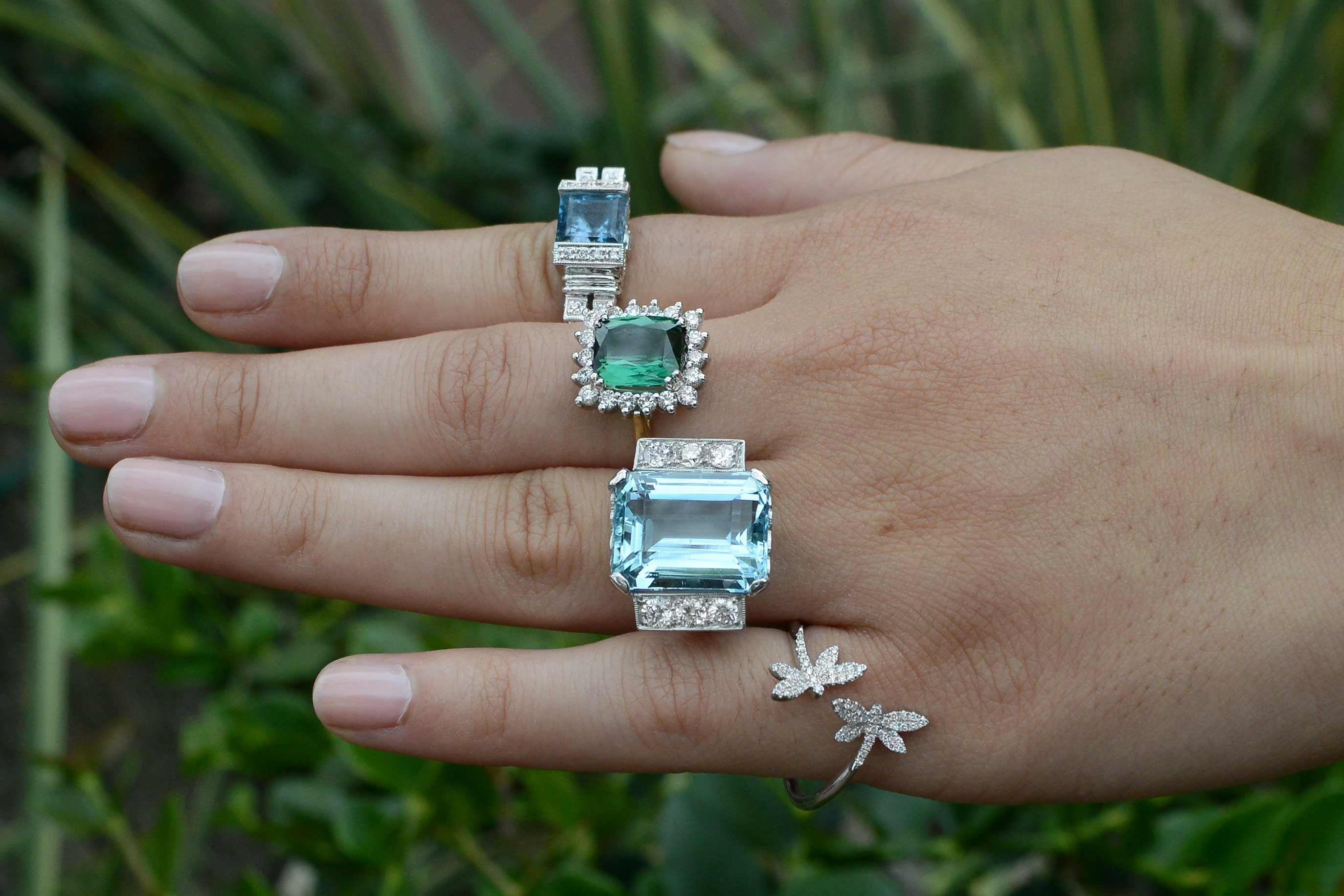 A swoon-worthy HUGE 15 carat Aquamarine statement jewel that will command attention. The emerald cut produces a most pleasing sky-blue hue (no yellow or greenish cast) and posing regally in it's original retro 1940s platinum setting, having gently