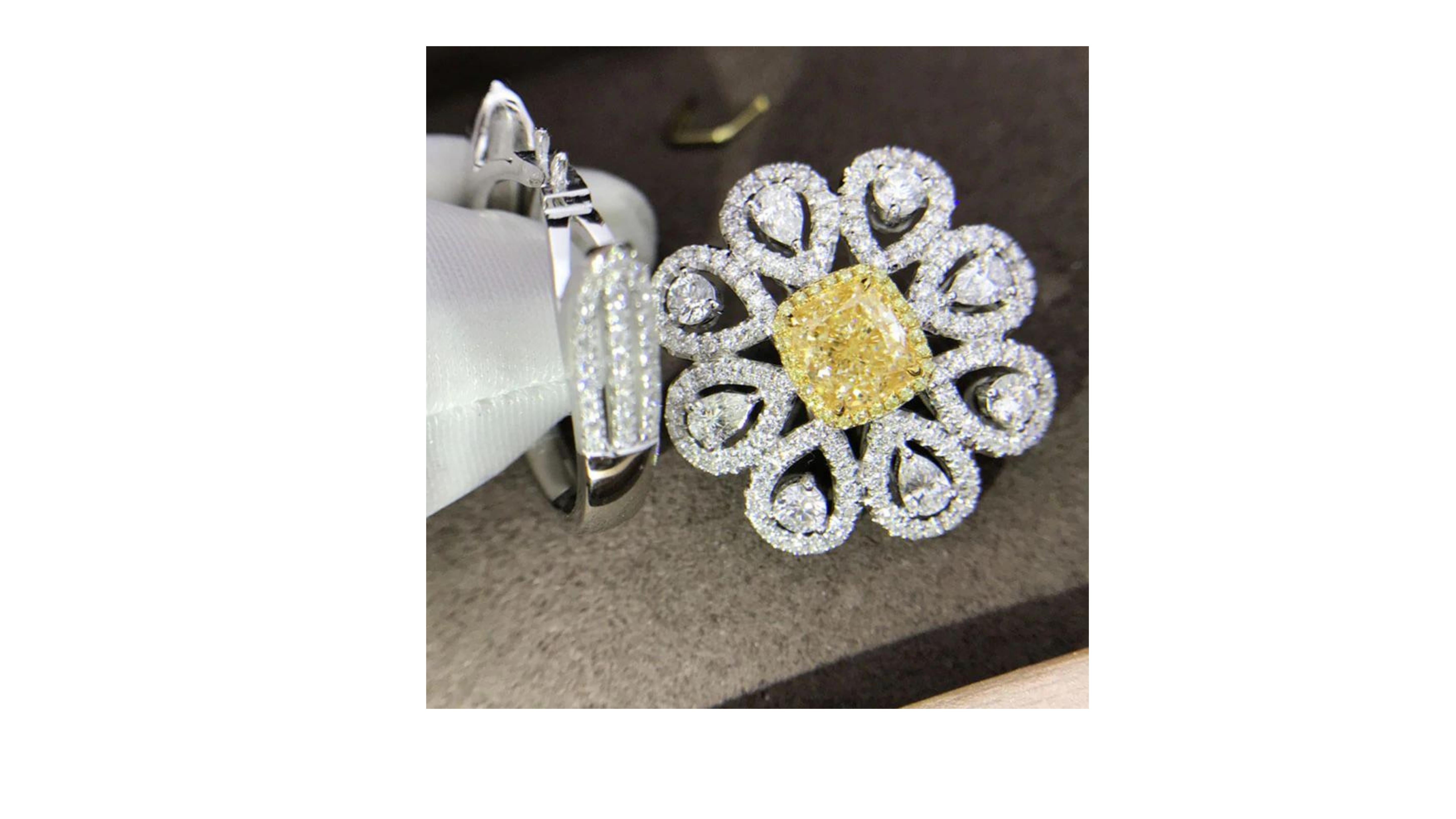 

This is a very unique and rare Fancy Yellow Diamond ring with 189 white diamonds around the centre stone making really stand out.  Set in 18 Karat White Gold. It can also be a necklace so has duel use.  If you are looking for anything specific let
