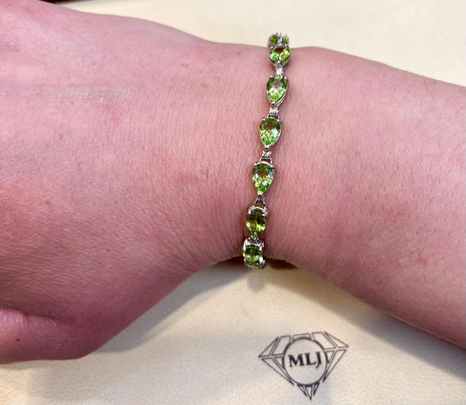  This exceptionally affordable Tennis  bracelet has  1 stones of Pear cut Peridot
Beautiful colors , very Vibrant
Size of the stone is approximately 7X5 mm
Each Peridot  is spaced by one brilliant round Diamonds.
Total weight of the Diamond is