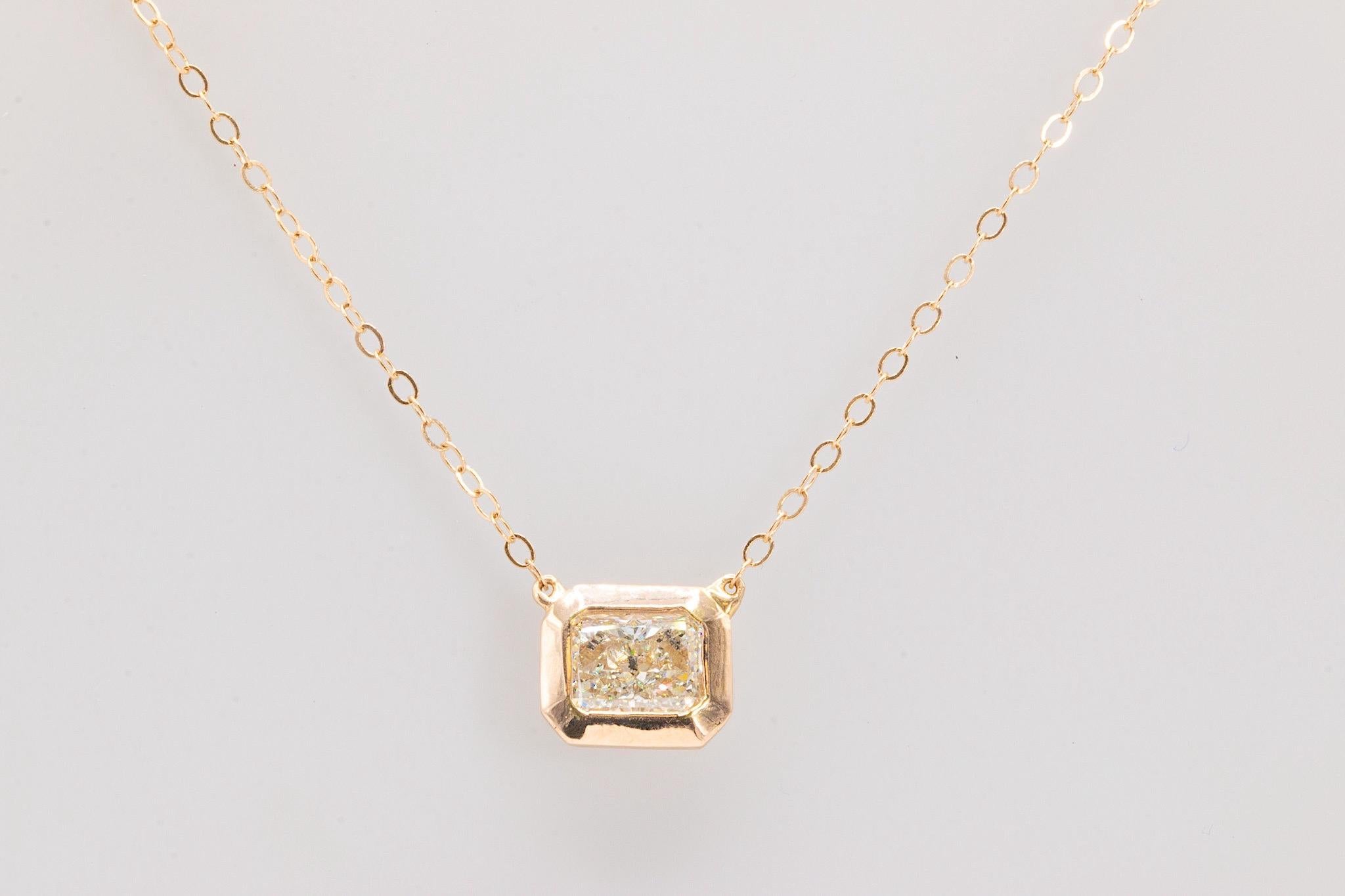 This exceptional custom-made necklace features a radiant-cut diamond elegantly set in a 