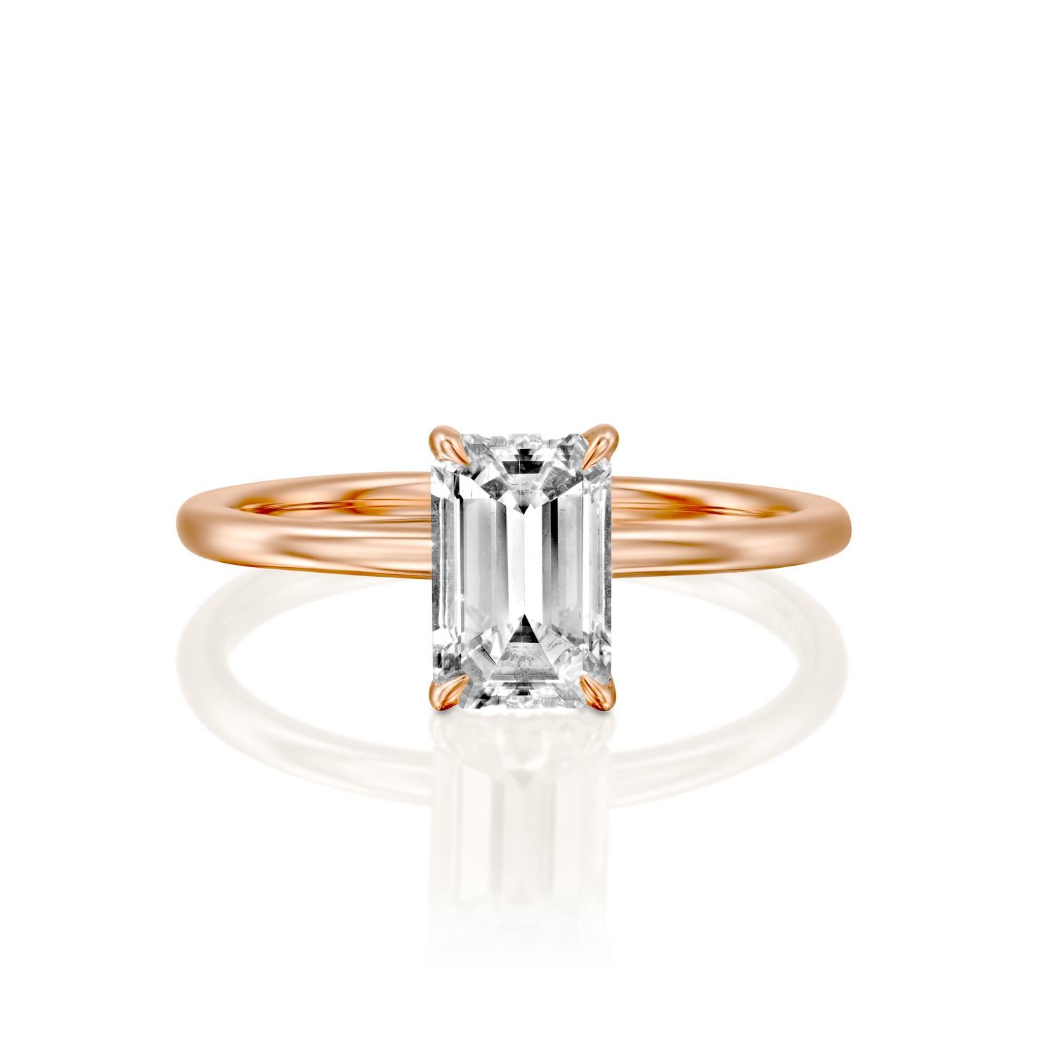 This breathtaking ring features a solitaire GIA certified diamond. Ring features a 1.5 carat emerald cut 100% eye clean natural diamond of F-G color and VS2-SI1 clarity. Set in a sleek, 18K rose gold, solitaire ring with a 4-prong setting, this