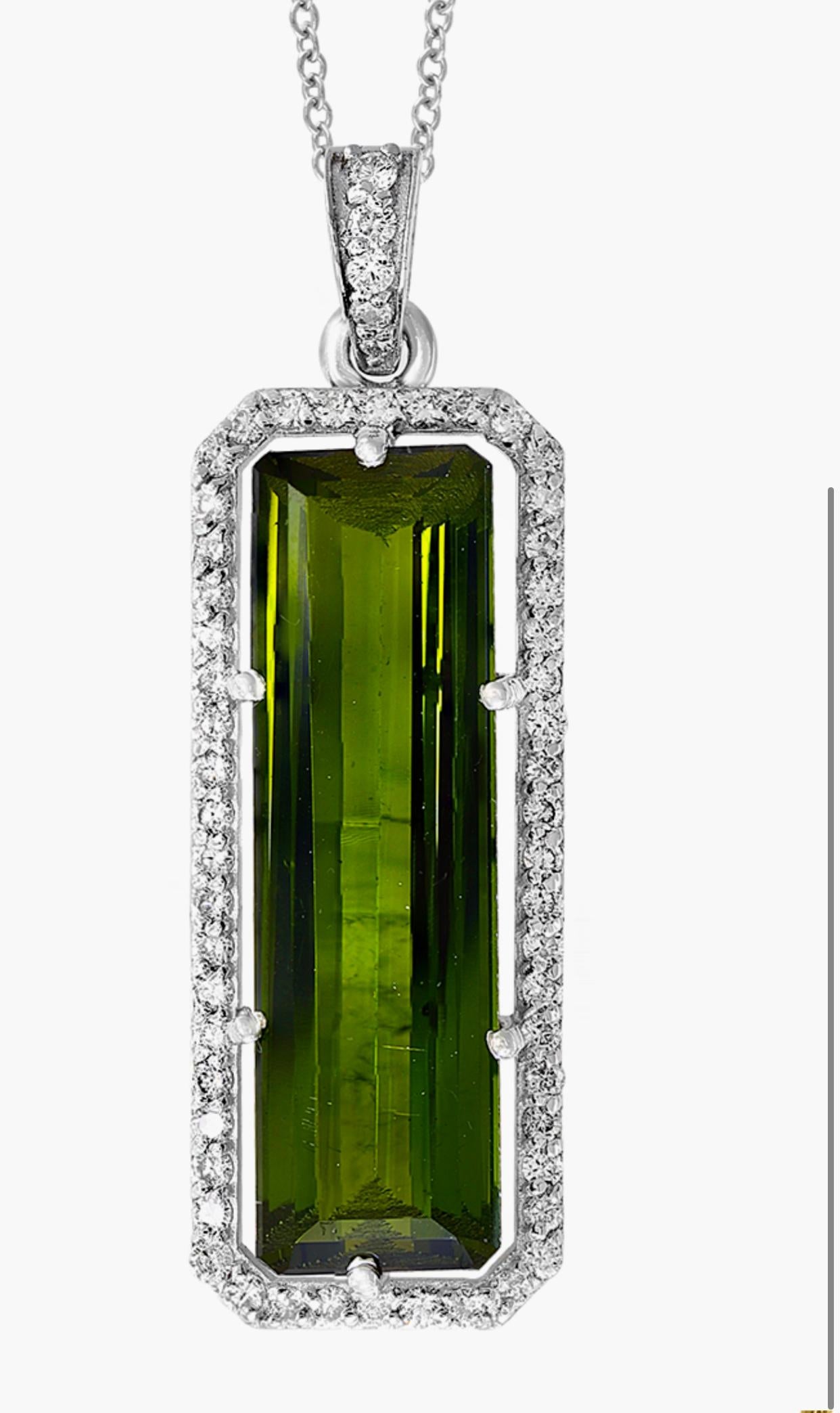  Approximately  15  Carat Green Tourmaline  & Diamond Pendant /  Necklace 18 Karat  Gold.
This spectacular Pendant Necklace  consisting of a single long Cushion  Shape Green Tourmaline  15  Carat.  The  Green Tourmaline  is surrounded by