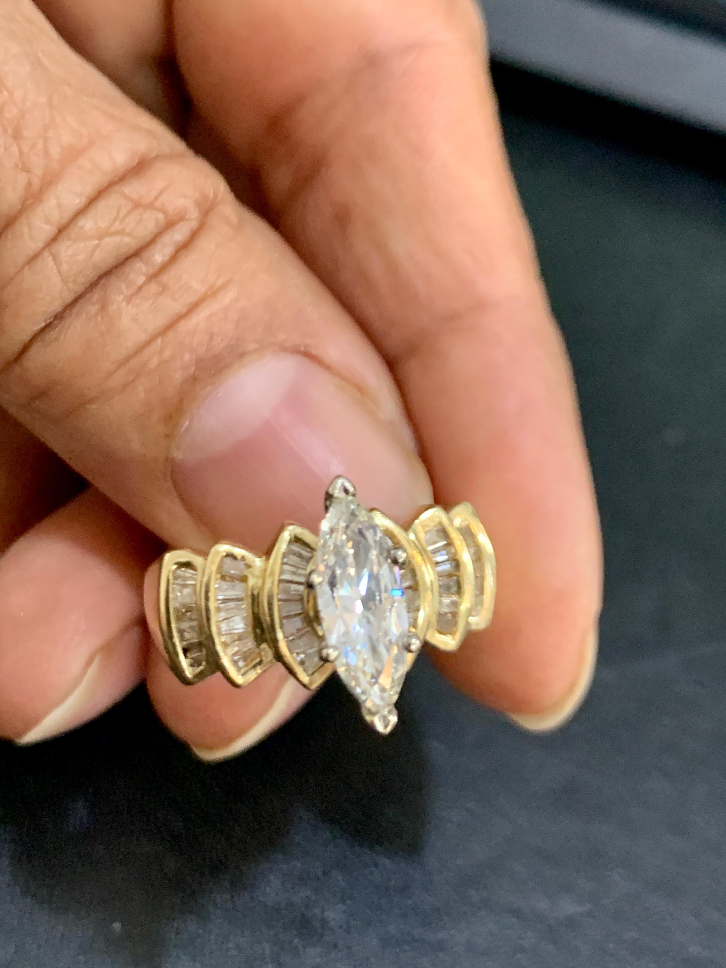 1.5 Carat Marquise Shape Center Diamond Engagement 14 Yellow Gold Ring
Prong set
14 K gold Stamped  6.6 Grams
Eye Clean diamond with lots of sparkle and brilliance. Big Bling !! The stones were not taken out to weigh , only measurements were done to