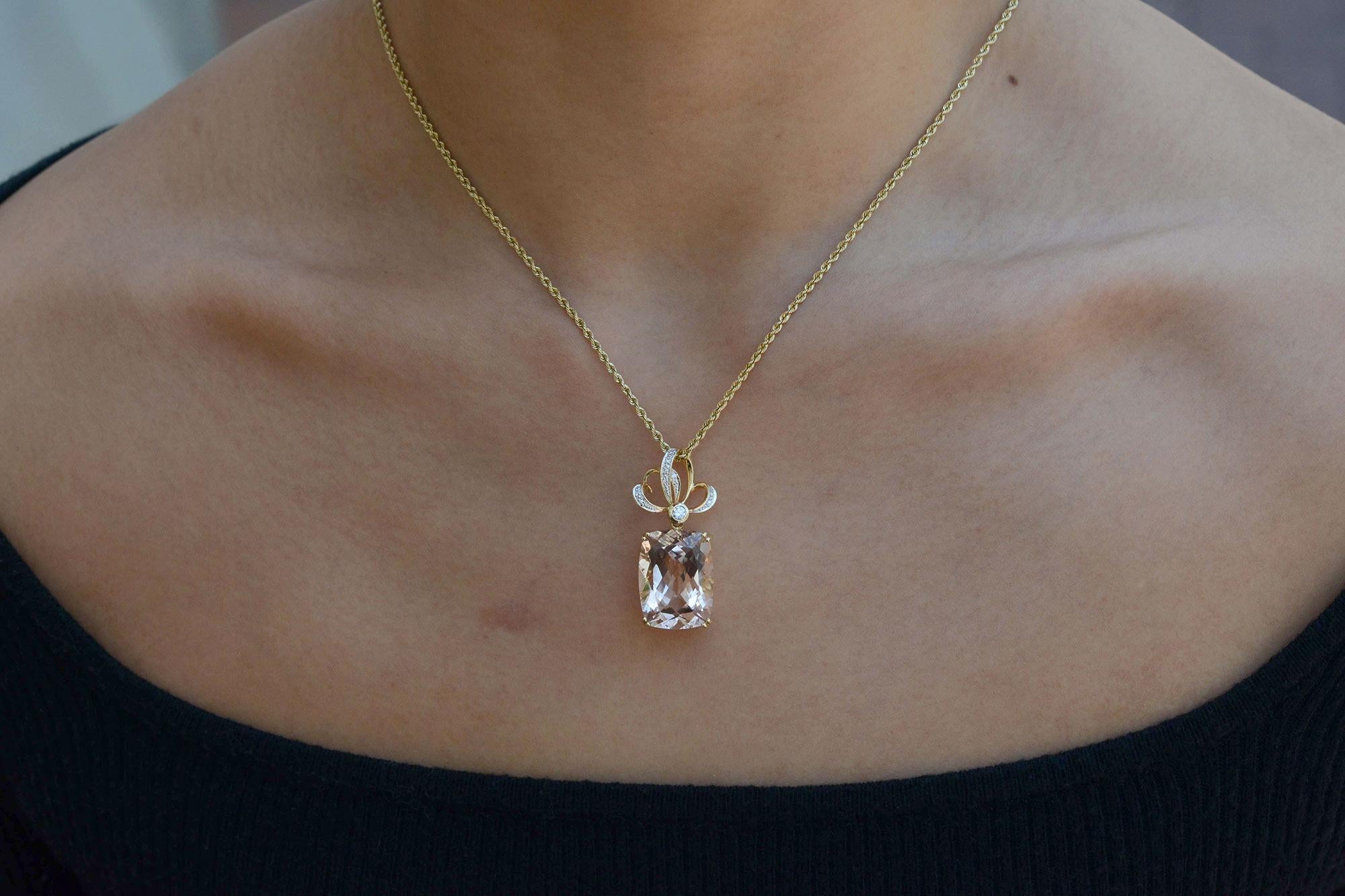 This beautiful 15 carat morganite and diamond pendant necklace is crafted with a modern contemporary style. Suspended below 10 twinkling round diamonds, the exquisite cushion cut gemstone radiates elegance and sophistication with a favorable