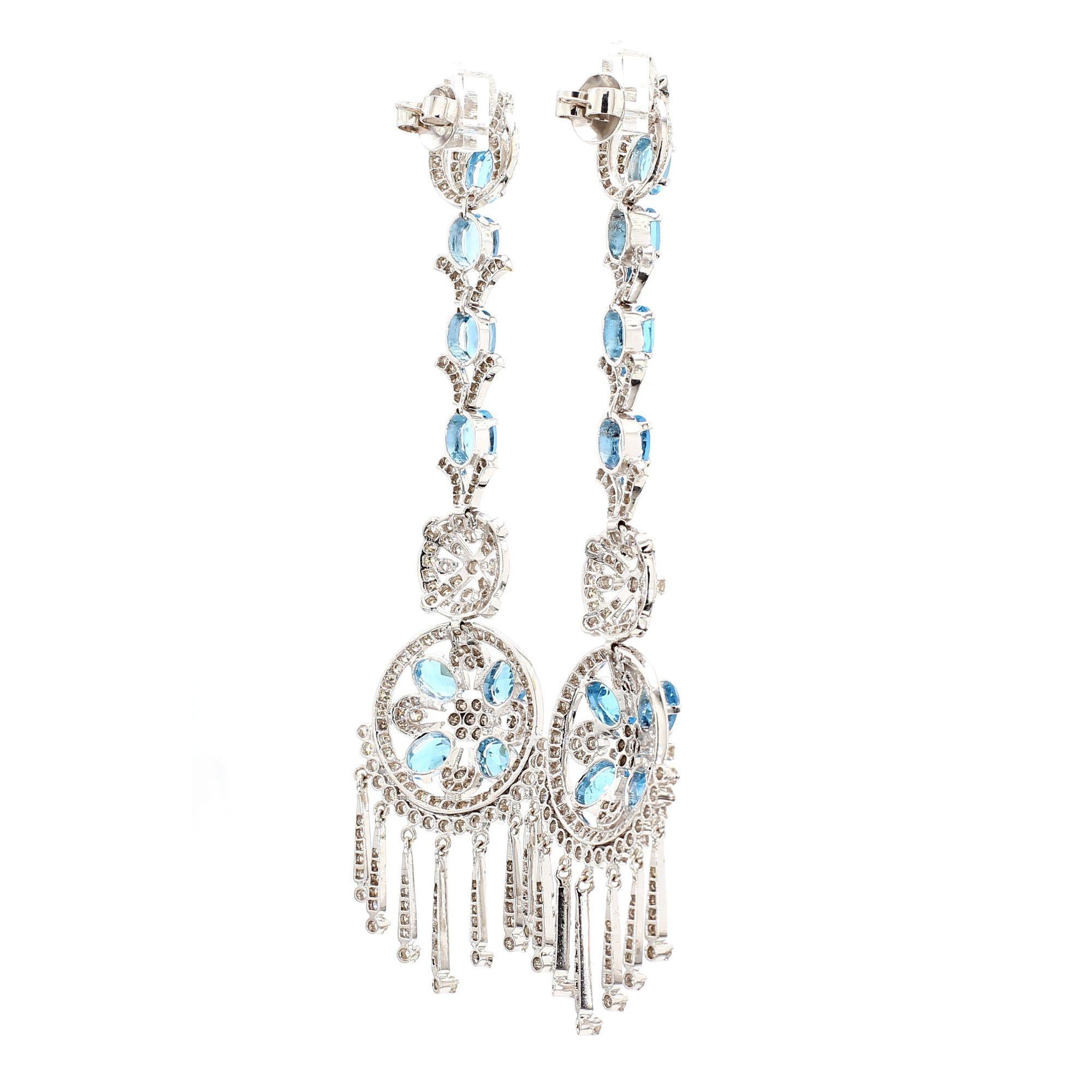 15 carat total weight of oval-cut aquamarines set in intricate diamond-accented retro inspired dangle earrings crafted in 18K white gold. Measures 4 inches long by 1 inch wide with push back closures, 30 grams.

Details:
Item Type: Dangle