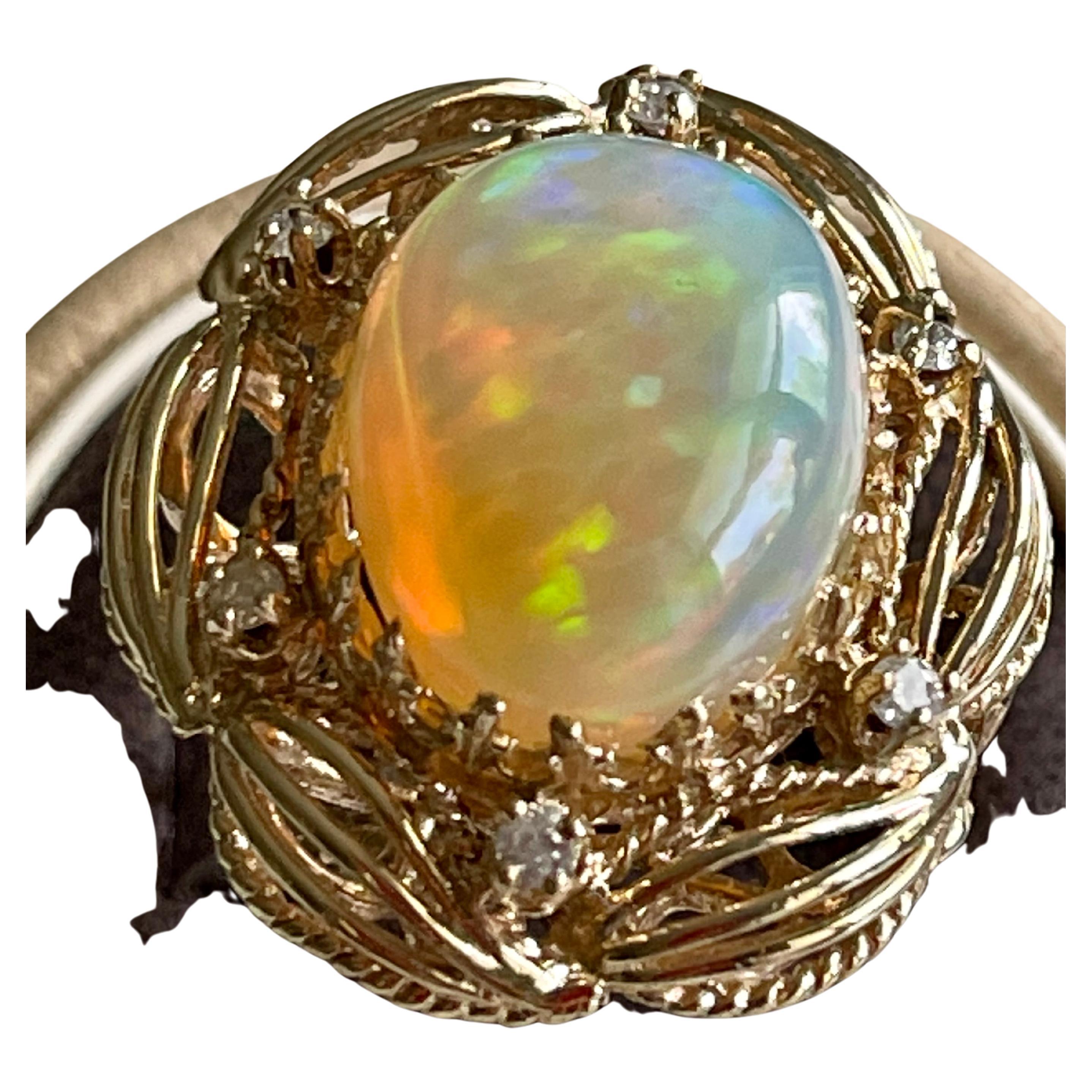 A Huge Cocktail ring 
Approximately 15 Carat Oval Ethiopian Opal  & Diamond Ring 14 Karat Yellow Gold Size 7
This spectacular Ring consisting of a single Oval Shape Ethiopian Opal Approximately 15 Carat. 

very clean Stone no inclusion , full of
