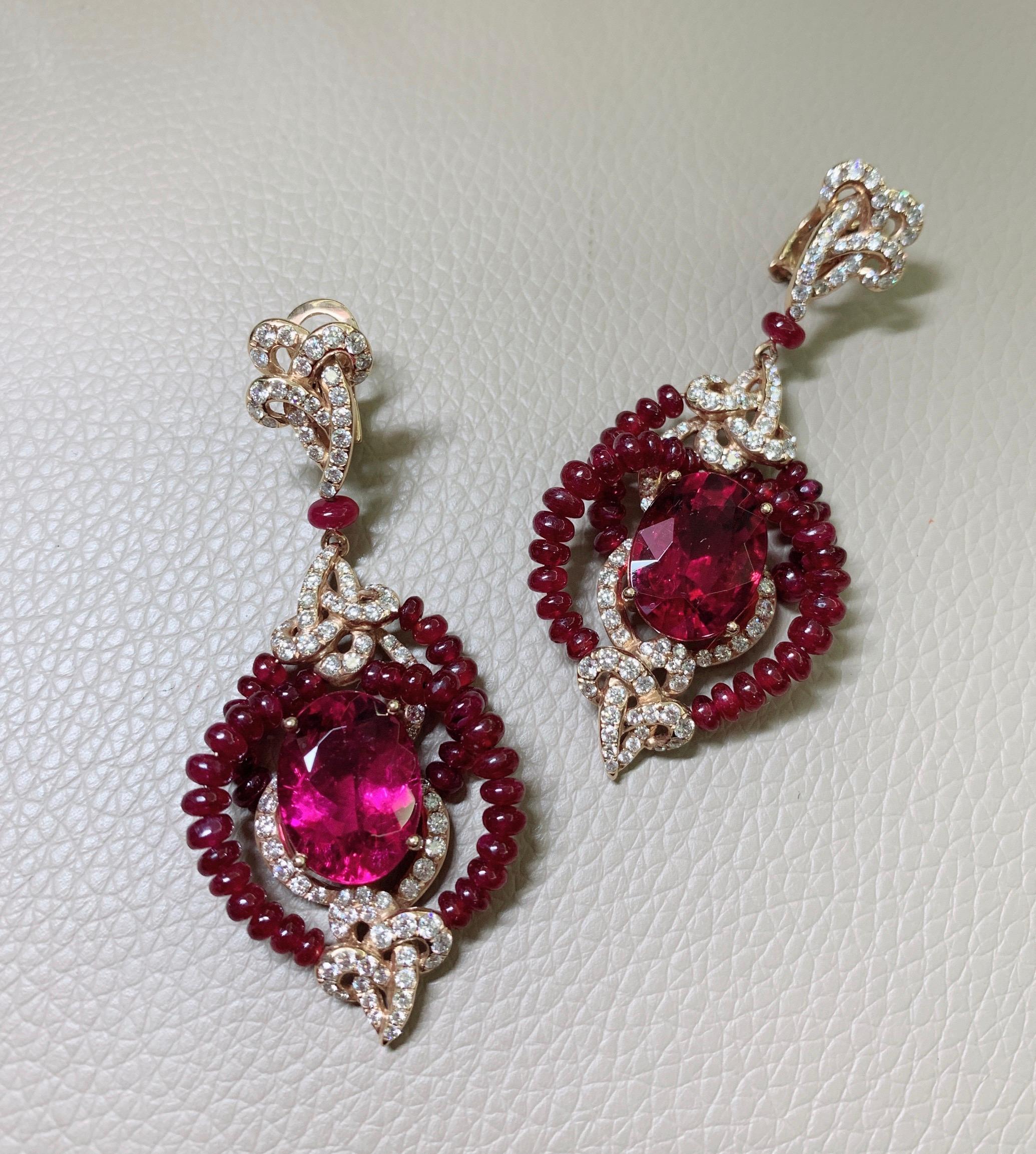 This pair of earring feature with a total 15 ct rubelite oval shape in center. surrounded with natural ruby beads and  white diamond design in 18k rose gold. 

Details information 
188 pcs, white diamond 2.98ct 
84 pcs, ruby beads 24.48ct 
2 pcs, 