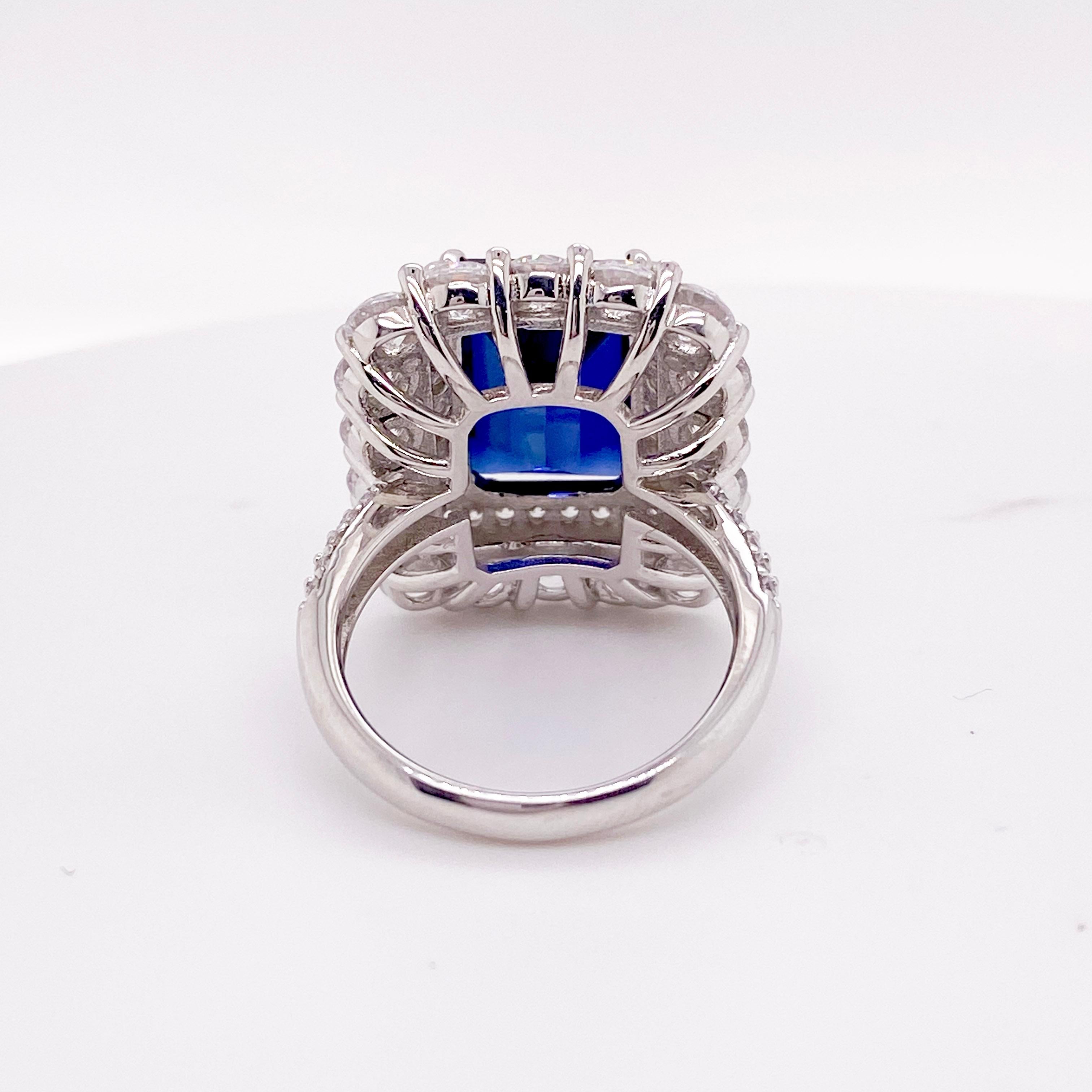 Striking Diamond & Sapphire Ring! This stunning ring is a gorgeous statement piece! Made with genuine natural diamonds and a genuine, blue sapphire gemstone. The center is a deep blue sapphire gemstone with an emerald cut, set in four claw prongs.