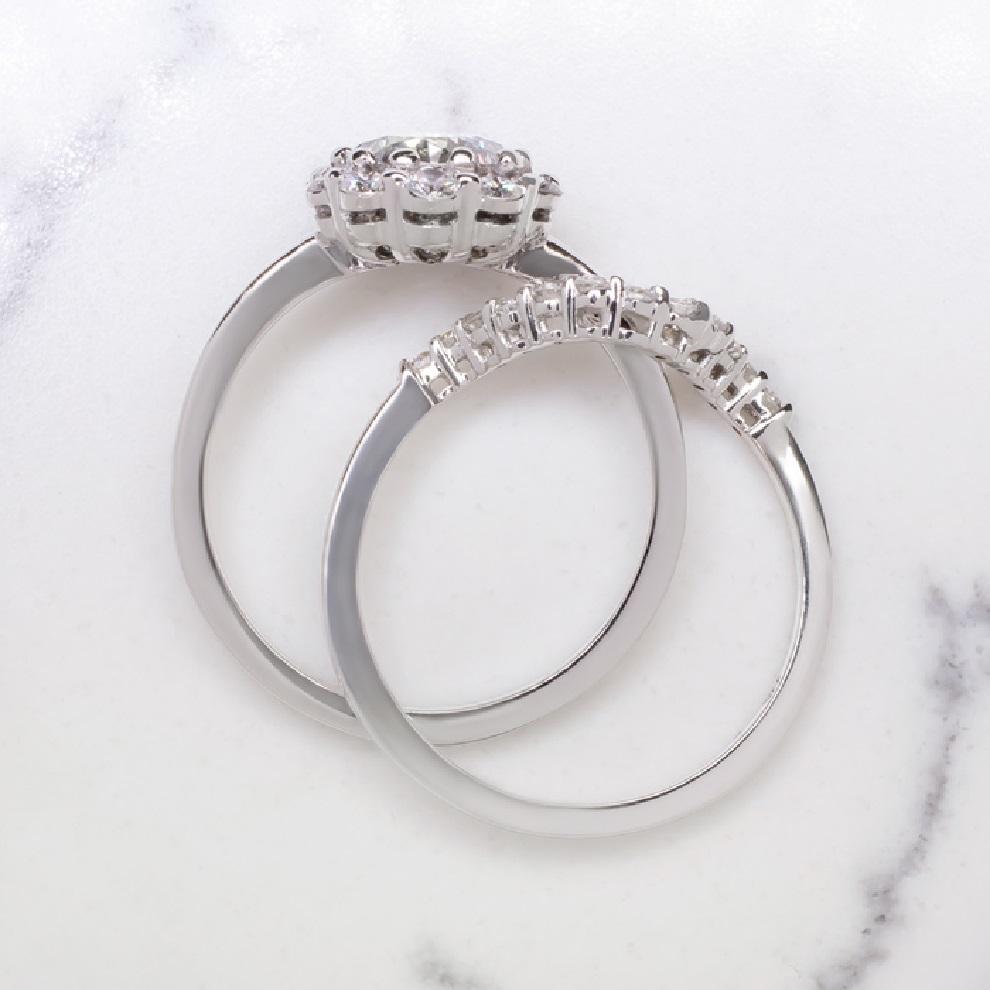 Gorgeous combination diamond wedding set. The engagement ring features a very well cut 0.96 carat round brilliant cut diamond surrounded by a prominent diamond halo.
The wedding ring is embellished with additional diamonds and shaped to perfectly