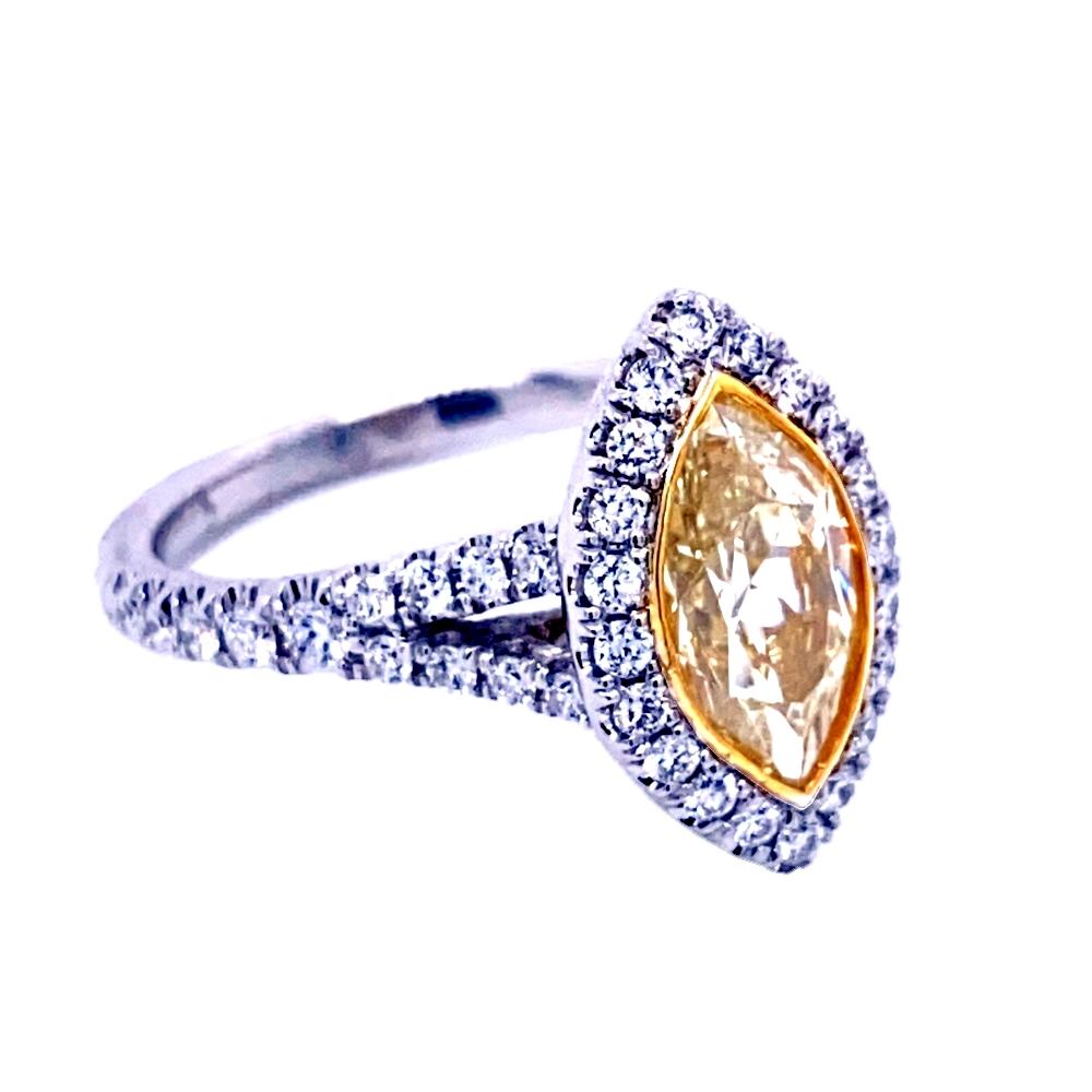 A very fine 1.5 Ct Marquise shaped Natural Light Fancy Yellow - VS Clarity center Diamond set in a fine 18k gold pave set Split Shank Engagement Ring with halo with total weight of 0.61 Ct diamonds on the side. #sayitwithyellow
