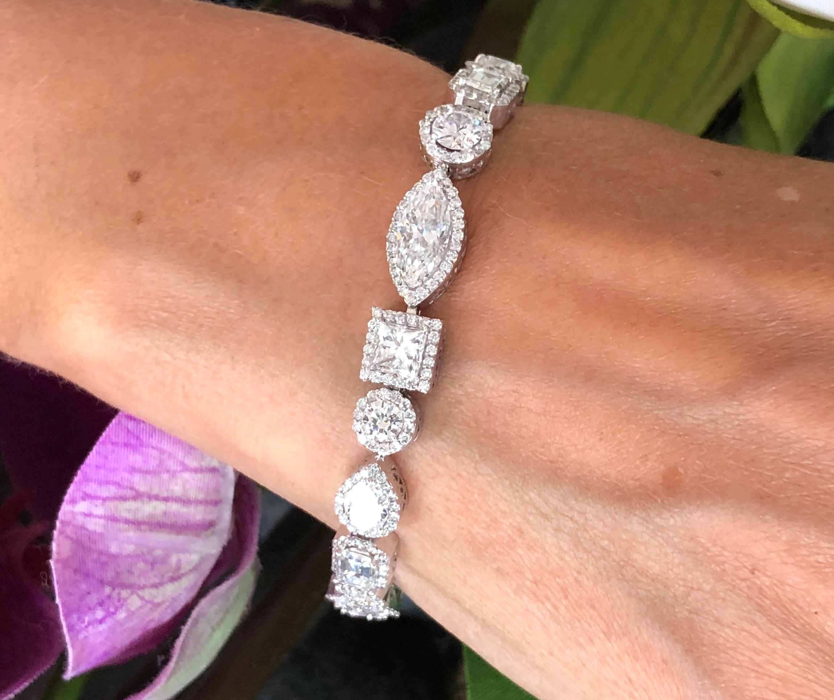 Offered here is a magnificent fancy shape diamond bracelet set in 18kt white gold. The bracelet measures about 7.5” long by a little over 0.25” width and weighs 24.40 grams. The bracelet is marked 18kt. The center diamond is a Marquise cut with a