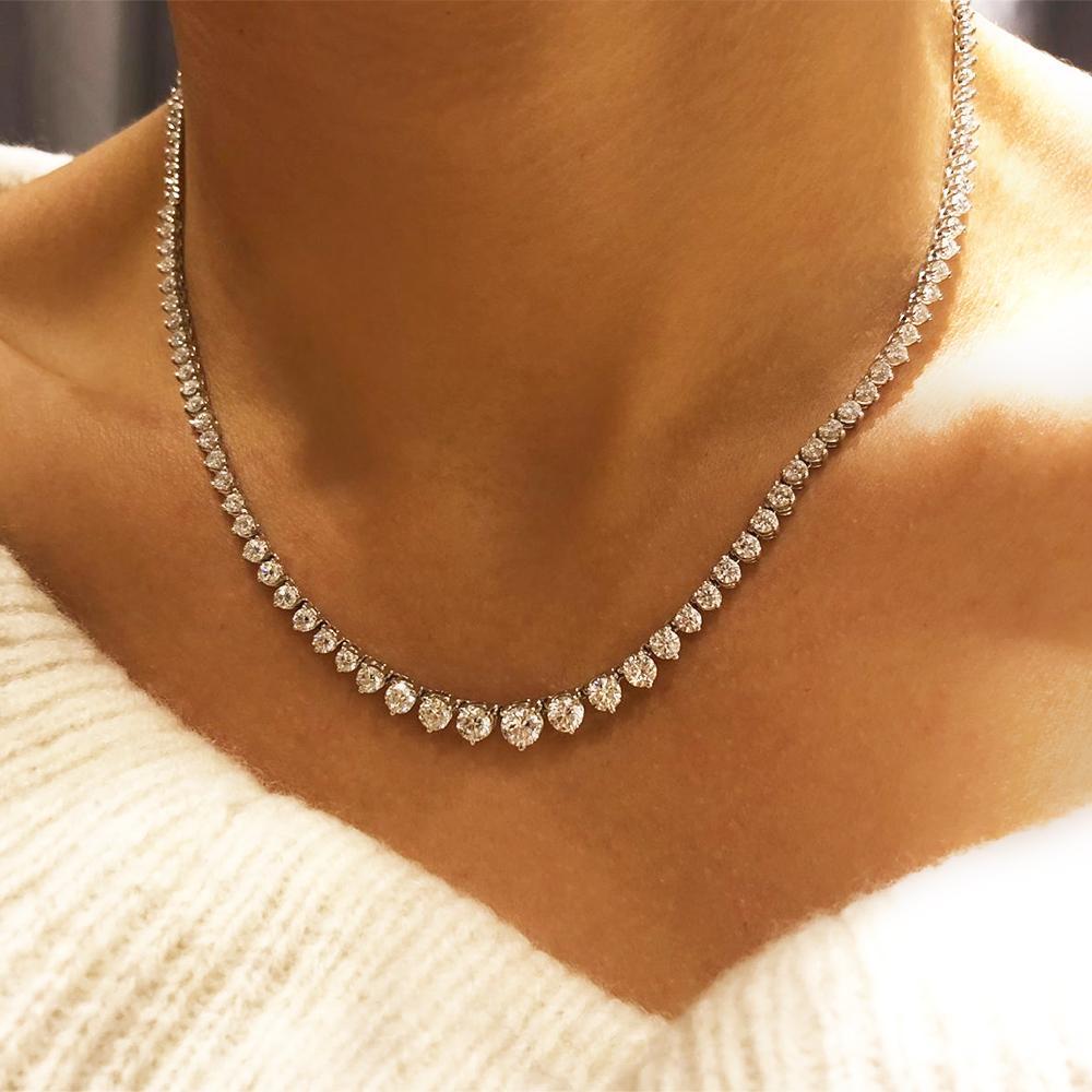 This exquisite diamond tennis chain is handcrafted in lustrous 18K white gold. The chain is prong set with lovely round cut diamonds which total to 15.00 carats. This chain securely locks with slide in hidden clap and one safety latch. This gorgeous