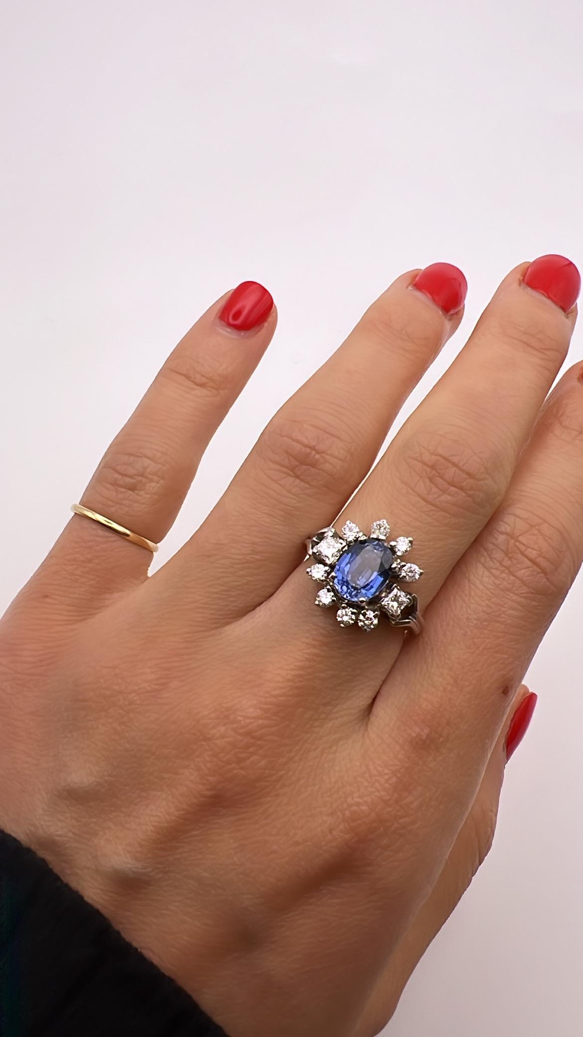 beautiful 18k white gold ring with blue sapphire .
the main stone surrounded by 8 brilliant cut diamond and 2 princess cut diamonds ,approximately 0.60
the diamonds are H color and Vs in clarity.