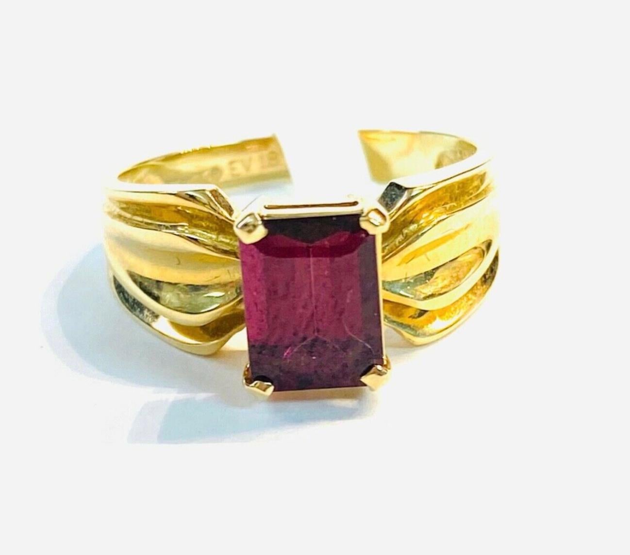 14k yellow gold emerald cut Garnet ring, 4.10 Grams TW. The dimensions of the emerald cut garnet are approximately 7.5 mm x 5 mm. Approximately 1.5 carats. Marked 14K. Approximate size 6.5.