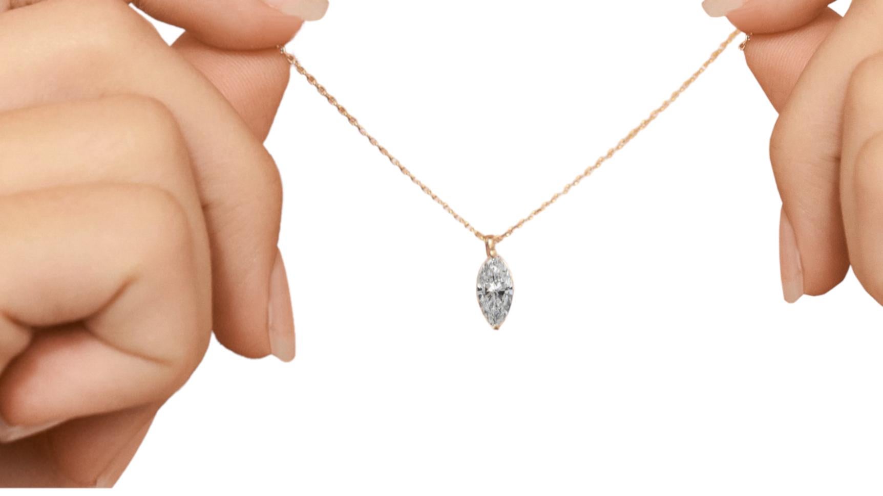 Fantastic solitaire pendant with 1.50 carat marquise cut diamond set in a 14Kt yellow gold setting and 14Kt yellow gold chain. 
The stone of the pendant is a marquise-cut diamond, an extremely refined cut that offers all its beauty set in a very