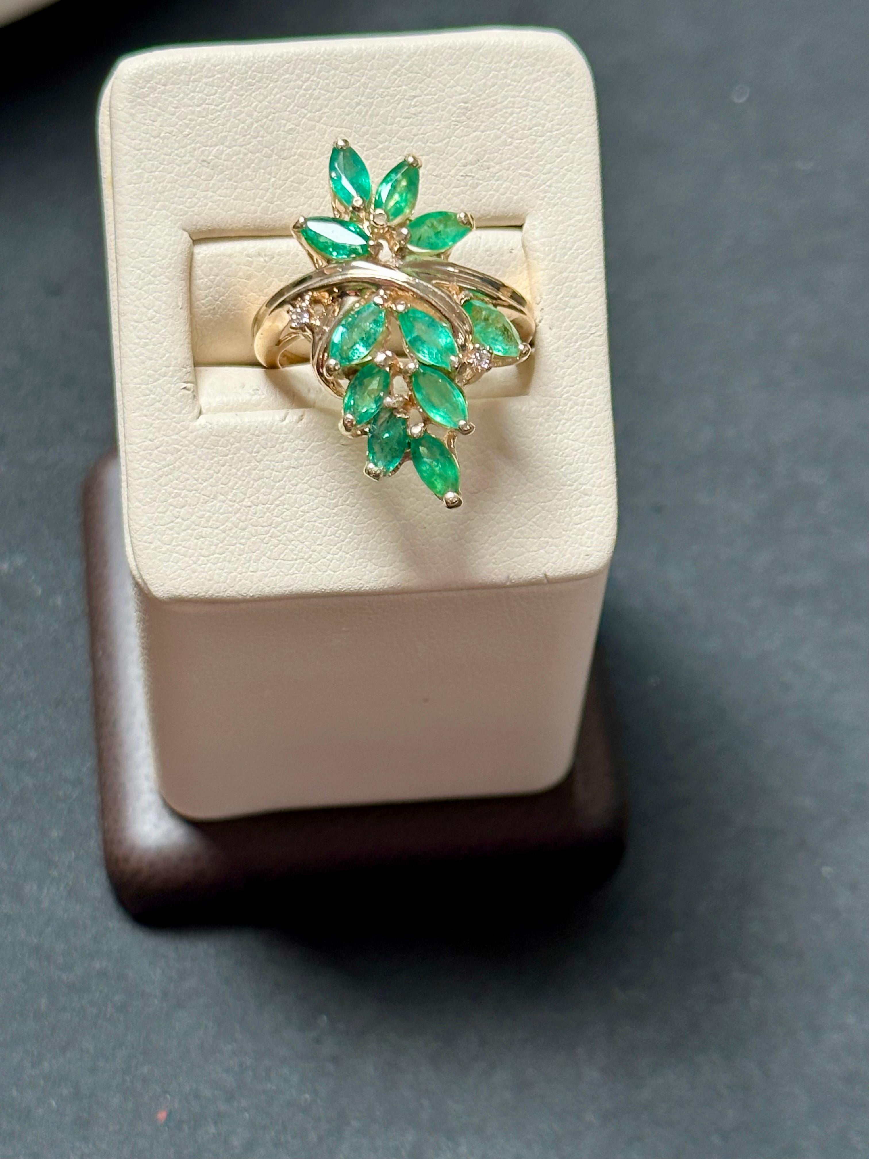 Introducing our exquisite 14 Karat Yellow Gold Ring featuring a collection of natural Brazilian emeralds and two tiny diamonds. This captivating ring showcases multiple marquise-shaped emeralds, known for their elegant and elongated form.

The total