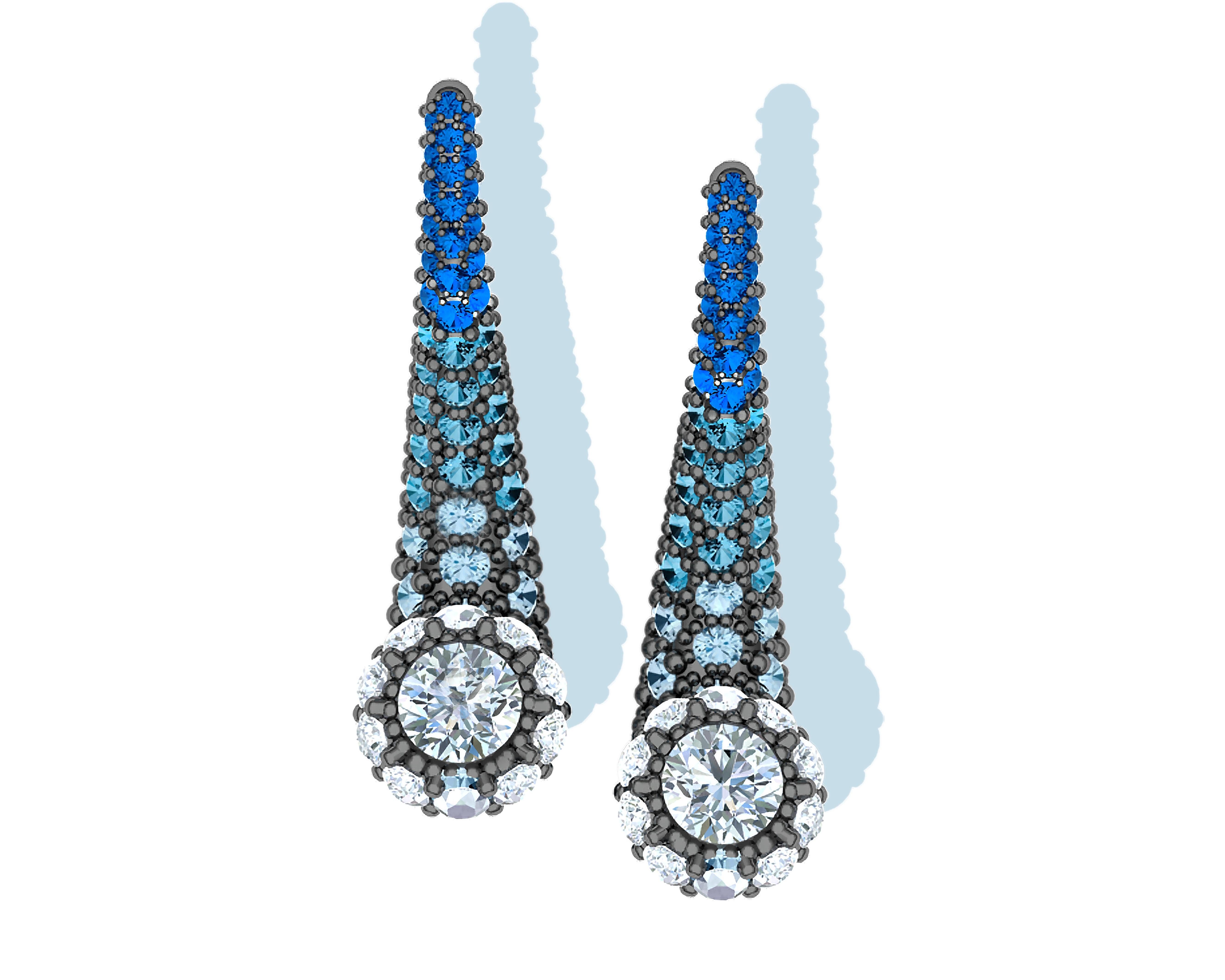 A beautiful gradual transition from white to pastel blue to rich royal blue is on display in this pair of modern yet timeless earrings.  These earrings have a .15 carat round white diamond centered at the tip of the earring where there's a rim of