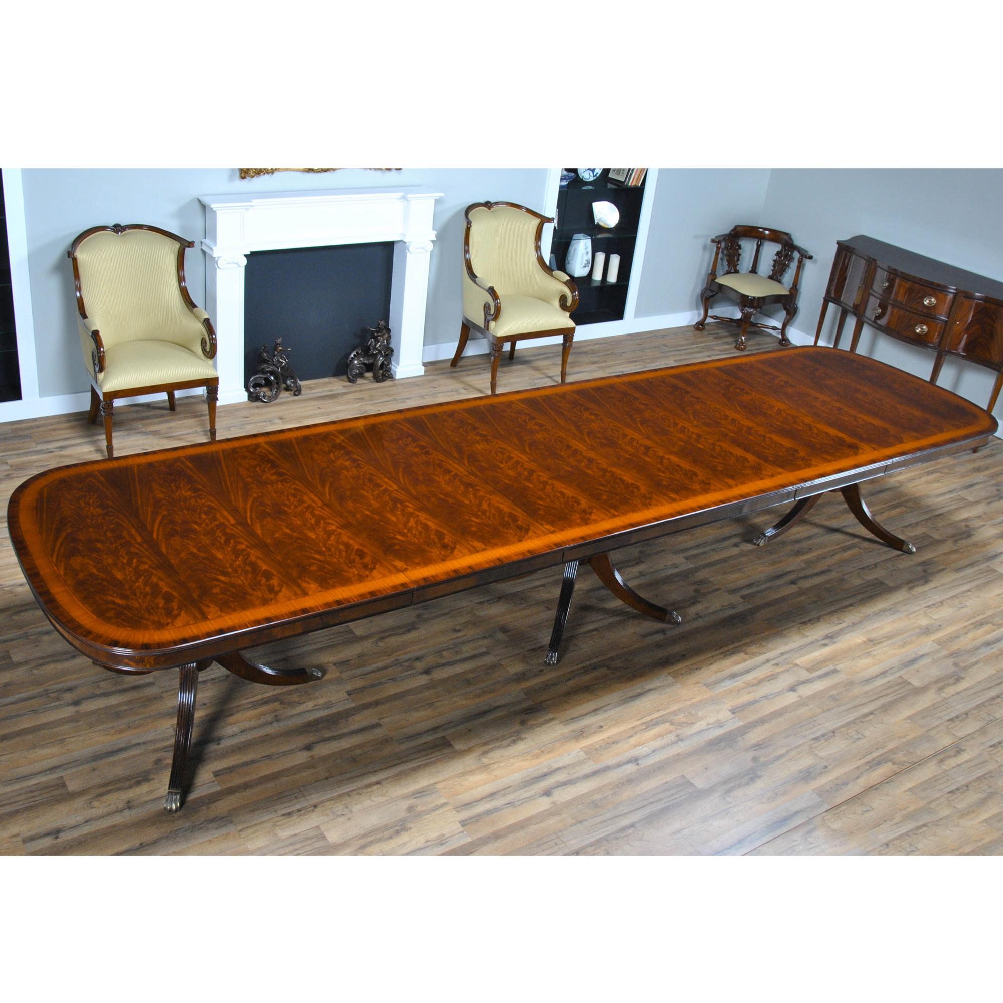 This version of a Three Pedestal 15 Foot Mahogany Dining Table has a lot of great features that combine to make it a show stopper. A reeded solid mahogany edge surrounds the table top and then flows into numerous bandings consisting of rosewood,