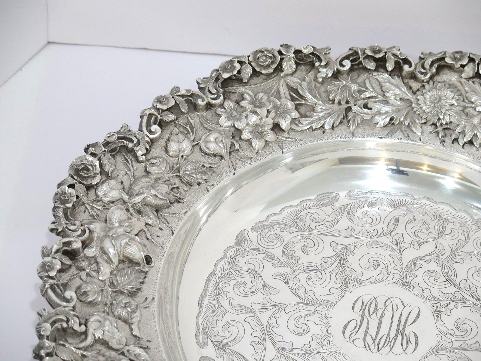 Weight: 55 toz. Measure: 15 in.

This is a museum-level sterling silver repousse large serving plate that was made by Samuel Kirk & Son.