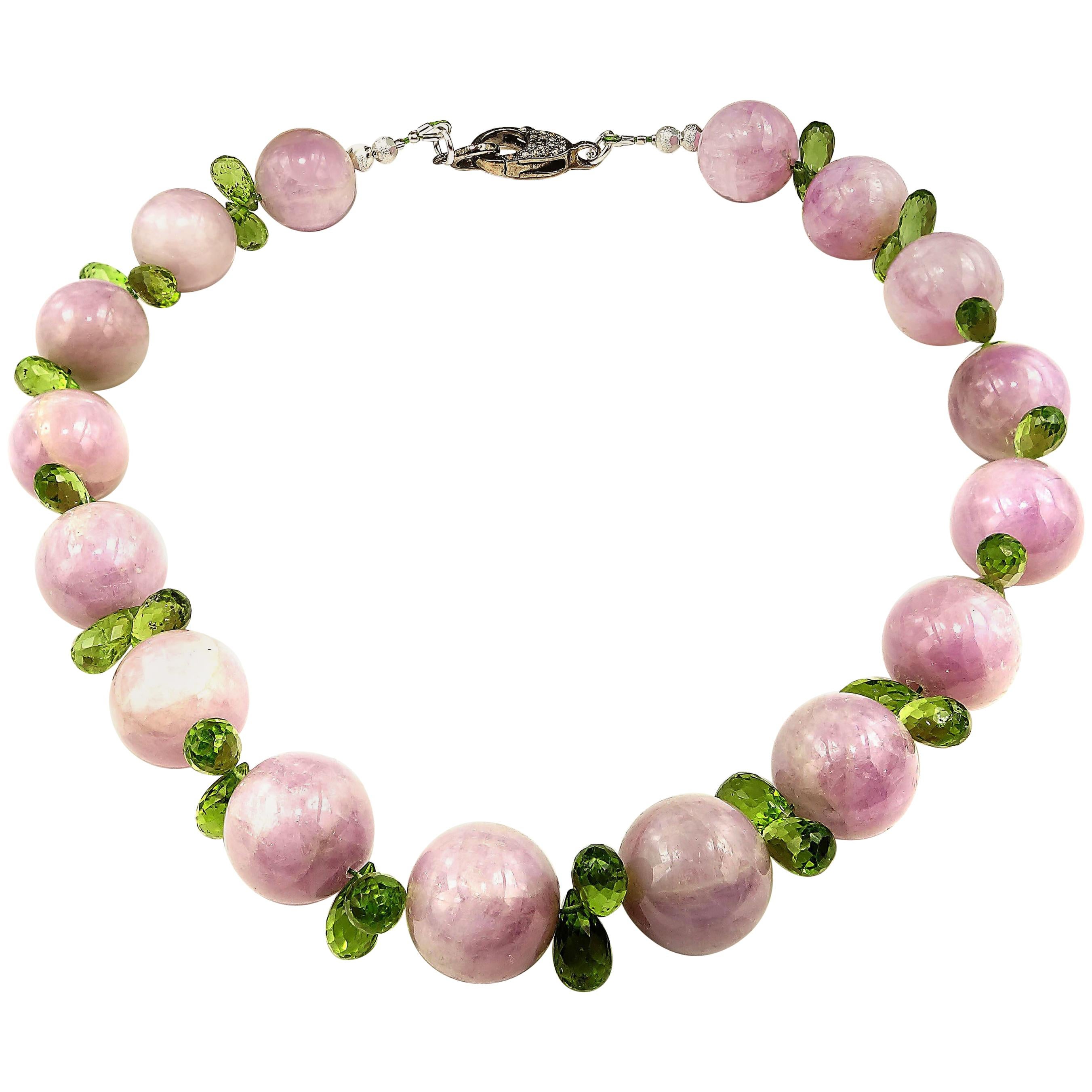 15 Inch choker necklace of glowing opaque Kunzite and sparkling Peridot briolettes.  This unique, handmade choker plays the sparkling bright green of the Peridot off the glowing mauvy pink of the Kunzite to bring out the best of both gemstones. The
