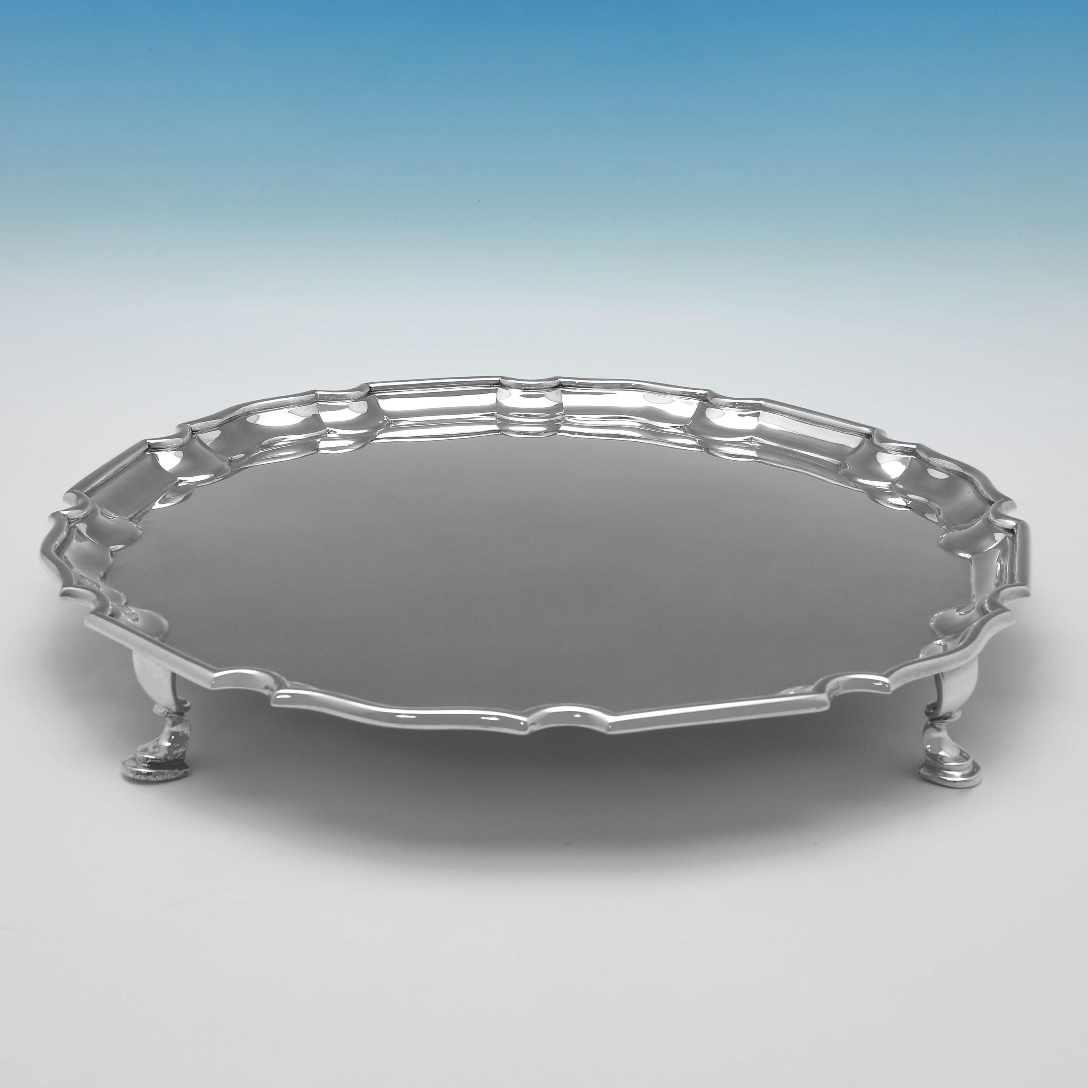 Hallmarked in London in 1899 by D. and J. Wellby, this handsome, Victorian, Antique Sterling Silver Salver, stands on 4 hoof feet, and features a 'Chippendale' border. 

The salver measures 1.75