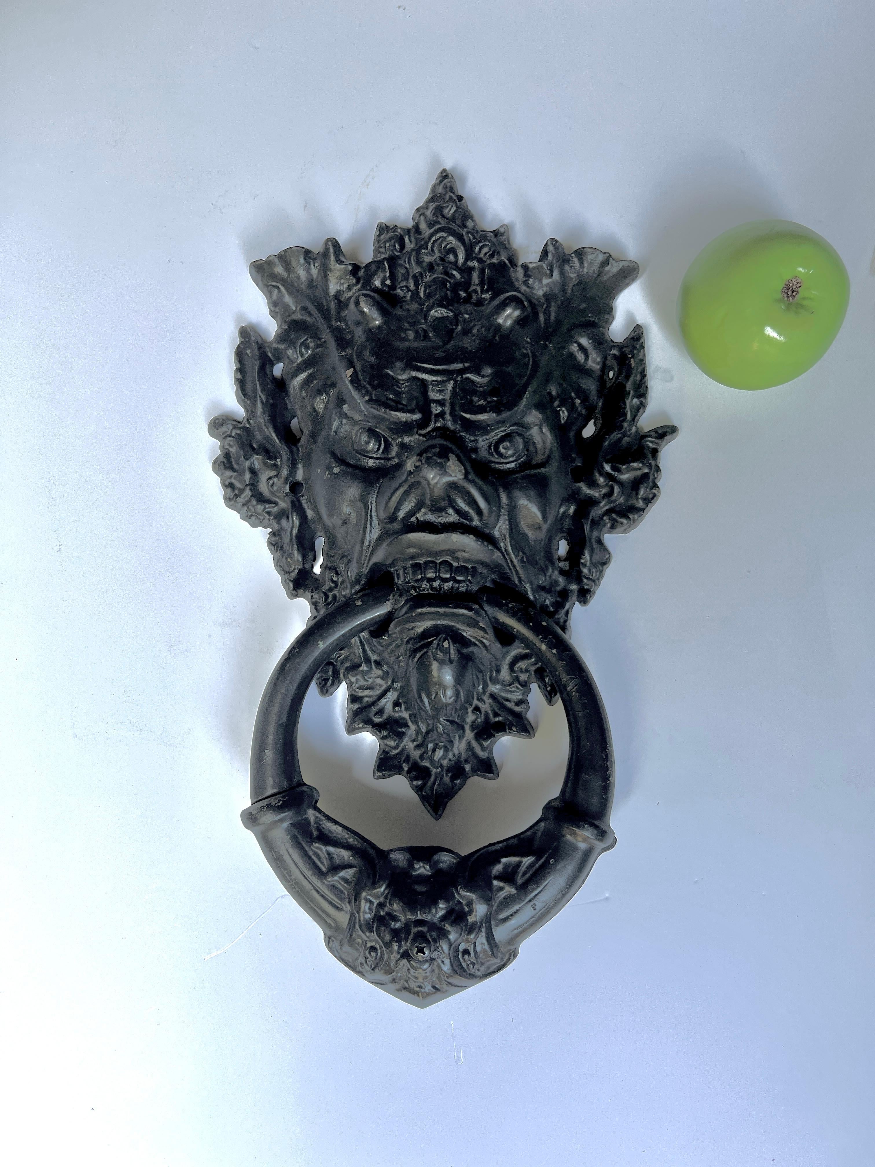 An English Solid Iron Door Knocker displaying an ominous Gargoyle.  The piece is very large at 15