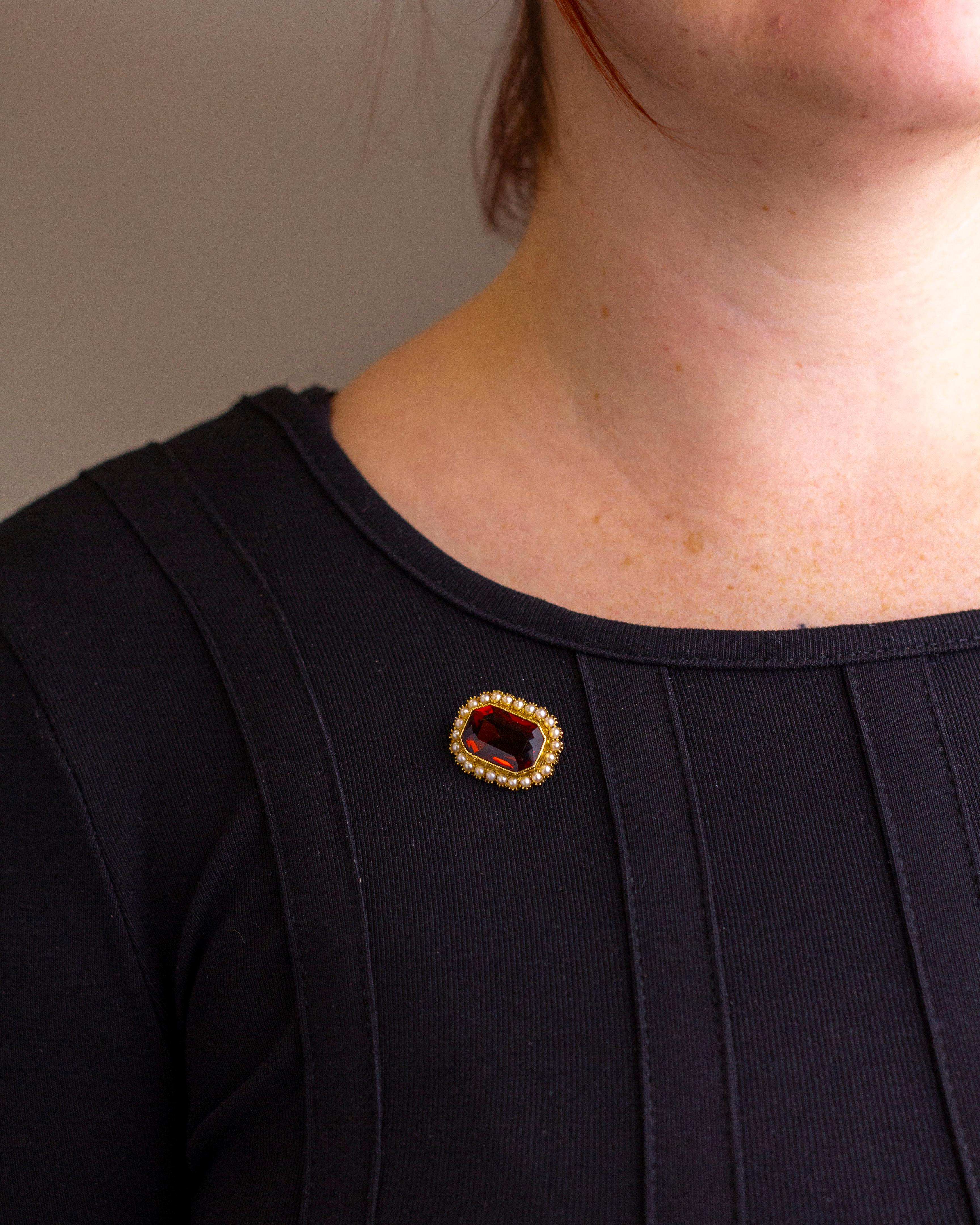 This charming little brooch dates to the Victorian period and was crafted from gold, seed pearls and a madeira citrine. The piece centres on an octagonal cut madeira citrine which is milgrain bezel set and surrounded by 24 seed pearls which are