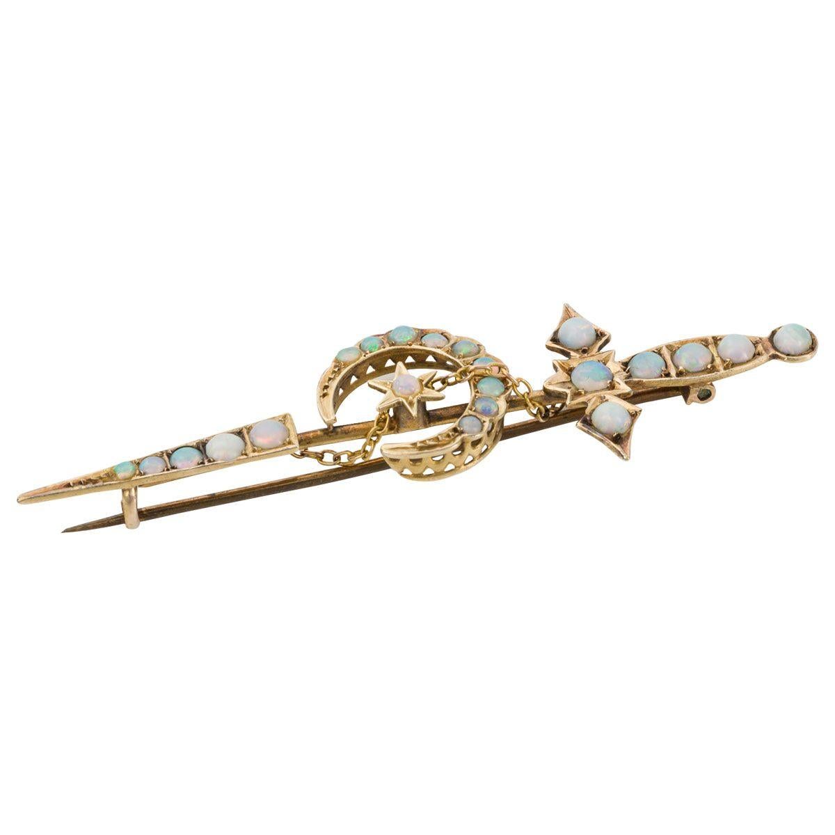 A little piece of Australian jewellery history with this lovely Willis & Sons sword pin, set with pretty cabochon cut opals. There are 22 bright and lively opals that show lots of rainbow colours from pinks, to greens, to reds. The pin is crafted