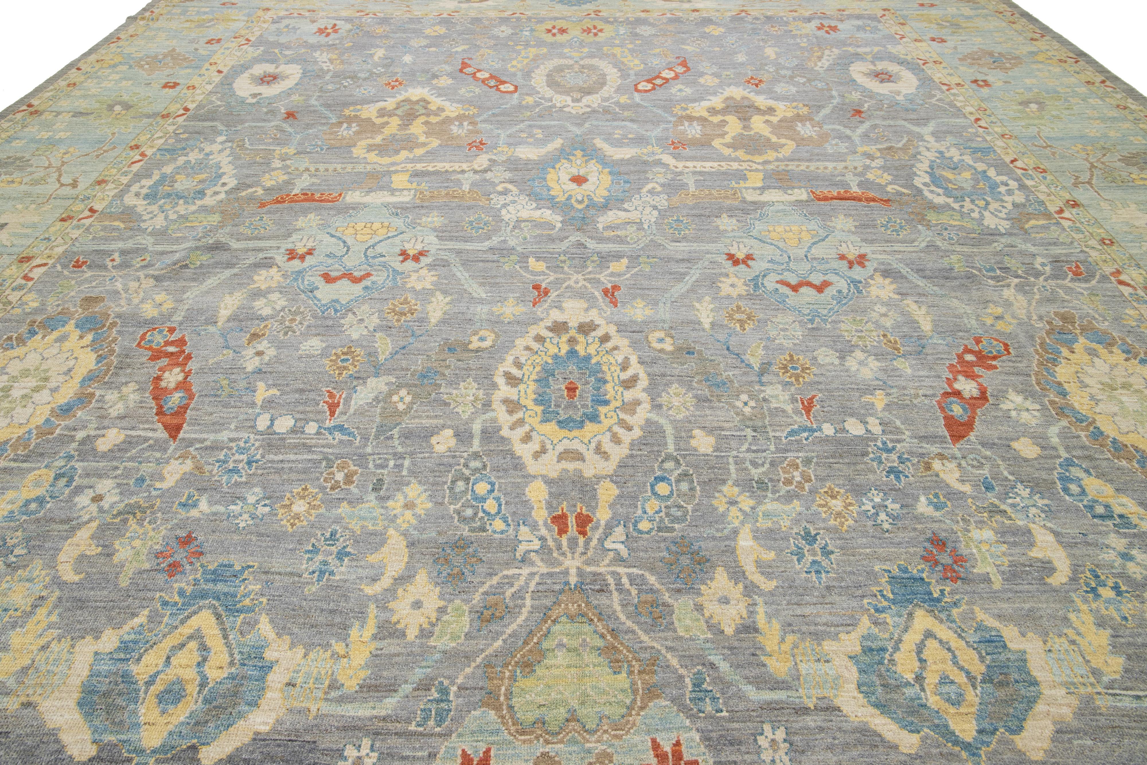 This oversized hand-knotted wool rug has a gray background adorned with multicolor accents all-over designs.

This rug measures 14'10 x 16'10''.